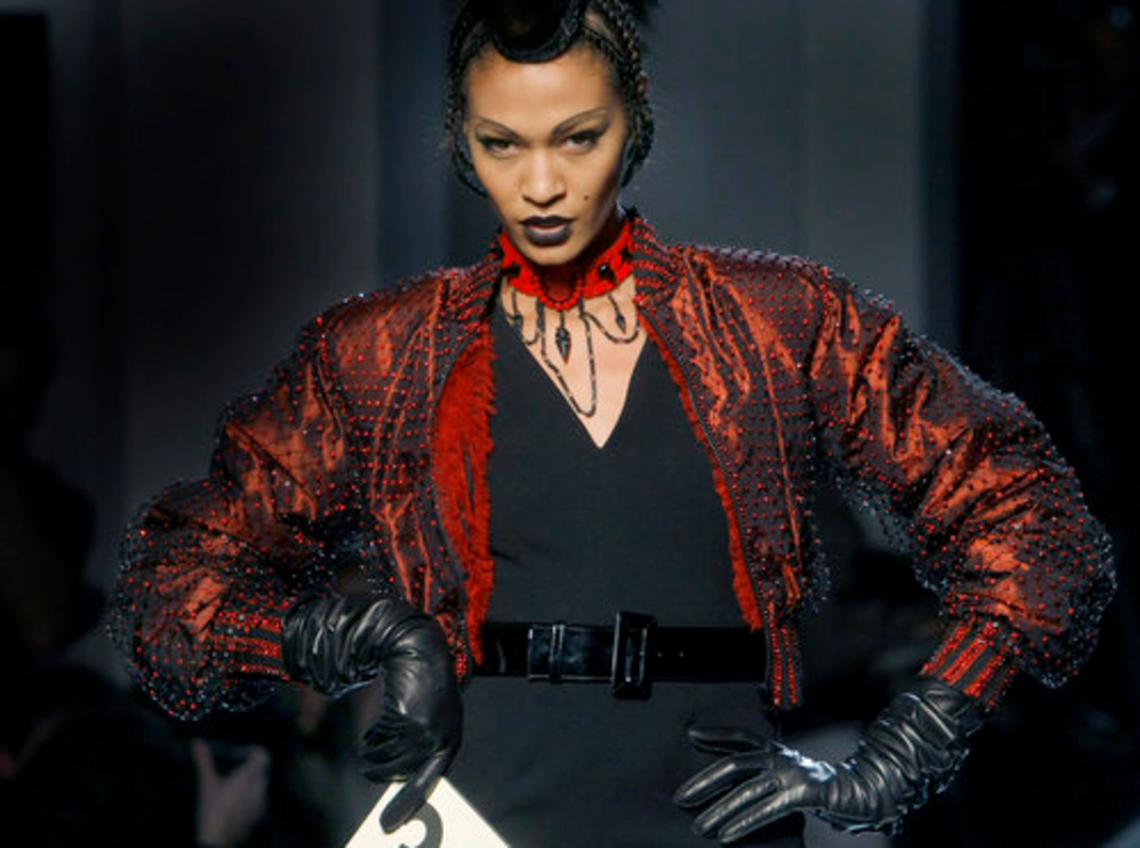 Look 36, "Stinky Toys," layered a ruby crystal-covered leather jacket over a pleated black evening number.