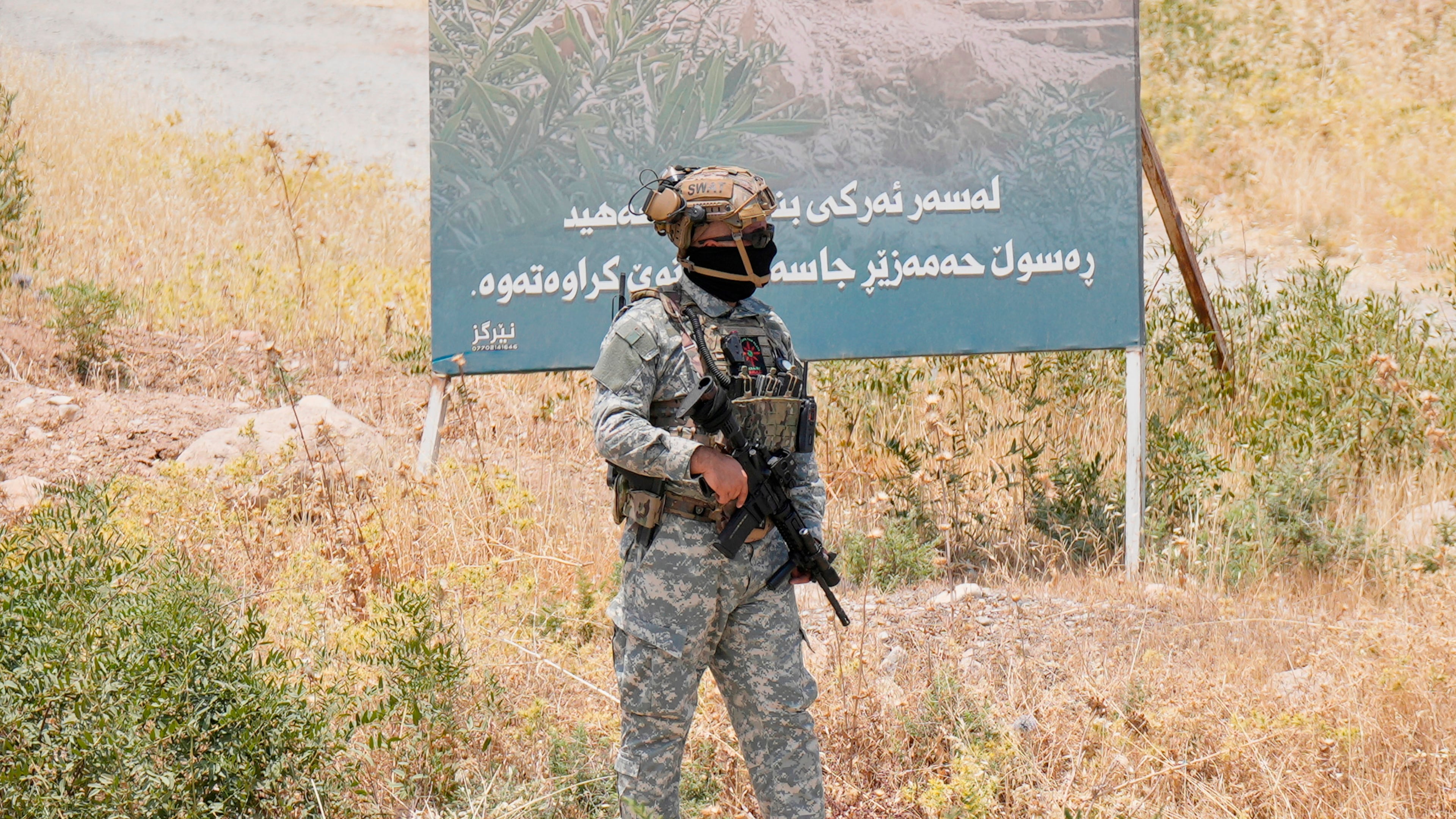 FILE - Forces of the regional Kurdish administration secure the area of the Jasana Cave ahead of a symbolic disarmament ceremony by the separatist PKK group as part of the peace process with Turkey, in Sulaymaniyah governorate, Iraq, July 11, 2025. (AP Photo/Hadi Mizban, File)