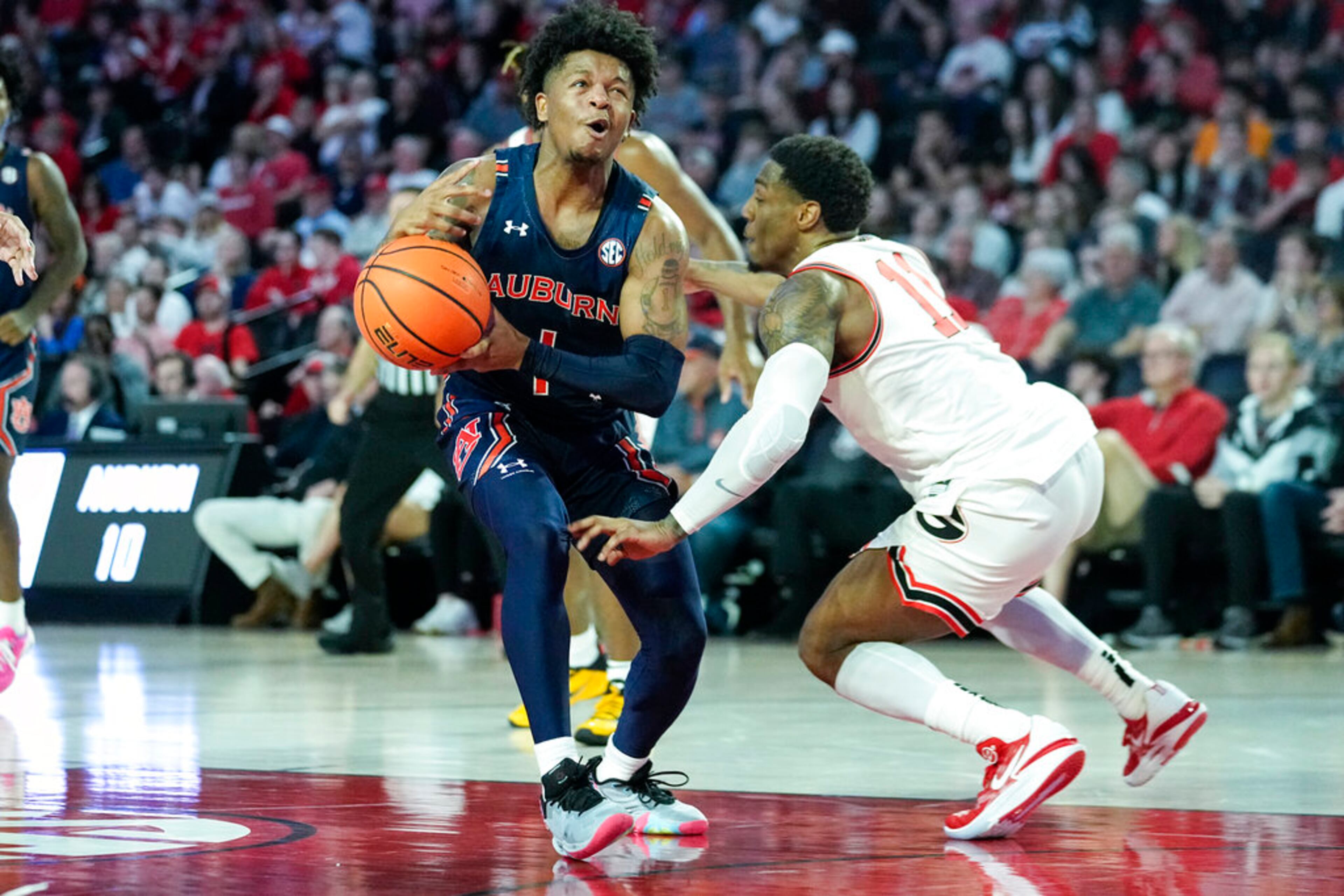 Auburn guard Wendell Green Jr. (1) drives against Georgia guard Justin Hill (11) during the first half of an NCAA college basketball game Wednesday, Jan. 4, 2023, in Athens, Ga. (AP Photo/John Bazemore)