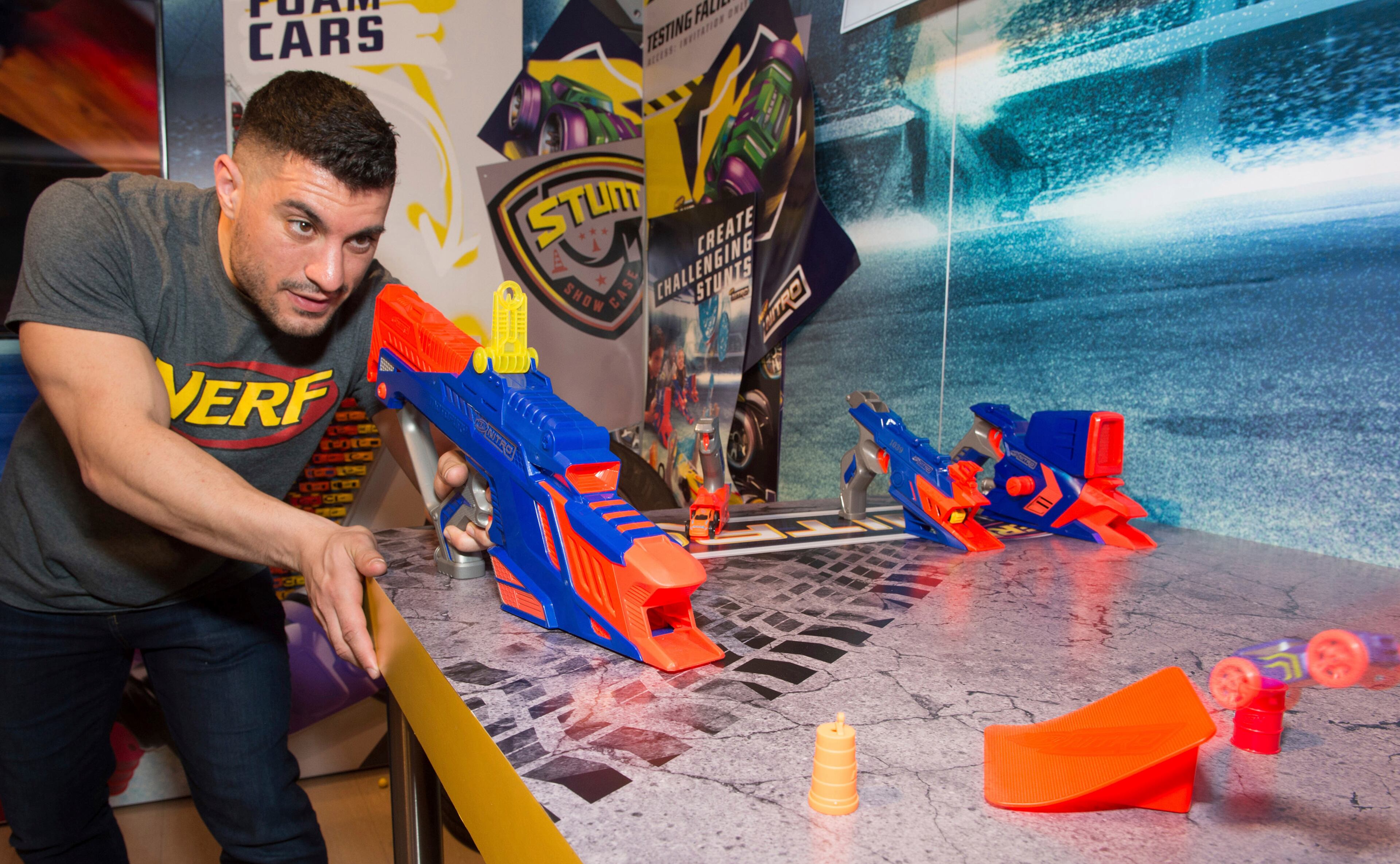 A demonstrator in the Hasbro showroom during the American International Toy Fair showcases the NERF NITRO line of launchable foam cars and blasters which debuts this year with more than 48 cars, stunt sets, and NITRO stunt car blasters, on Friday, Feb. 17, 2017 in New York. (Photo by Charles Sykes/Invision for Hasbro/AP Images)