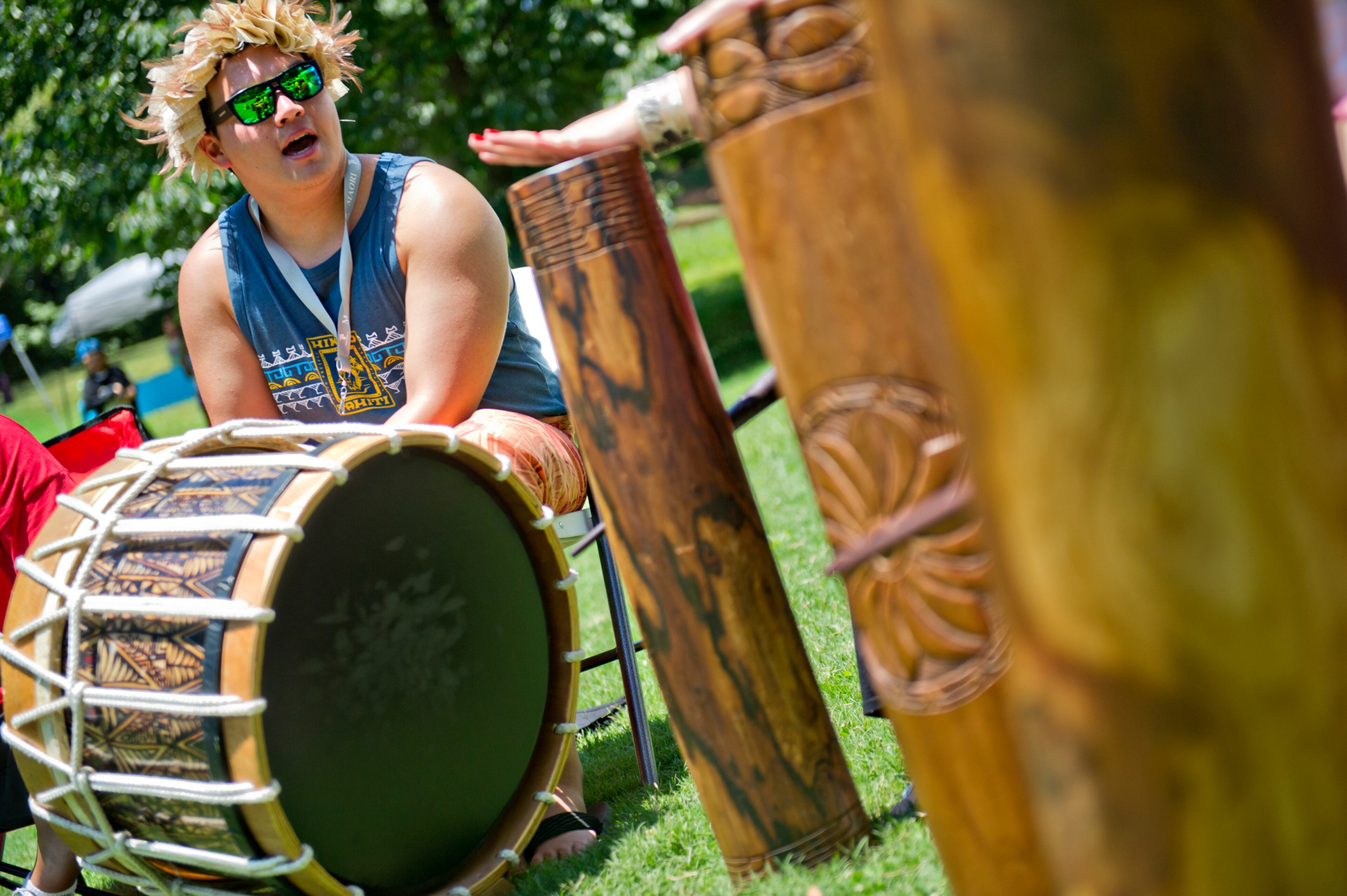 Kela Fisher bangs on a drum as he performs with his family during the Nezian Festival at Grant Park in Atlanta on Saturday, July 5, 2014. The two day festival brought together the culture and traditions of the South Pacific Islands with dance and music performances, food and local merchants.