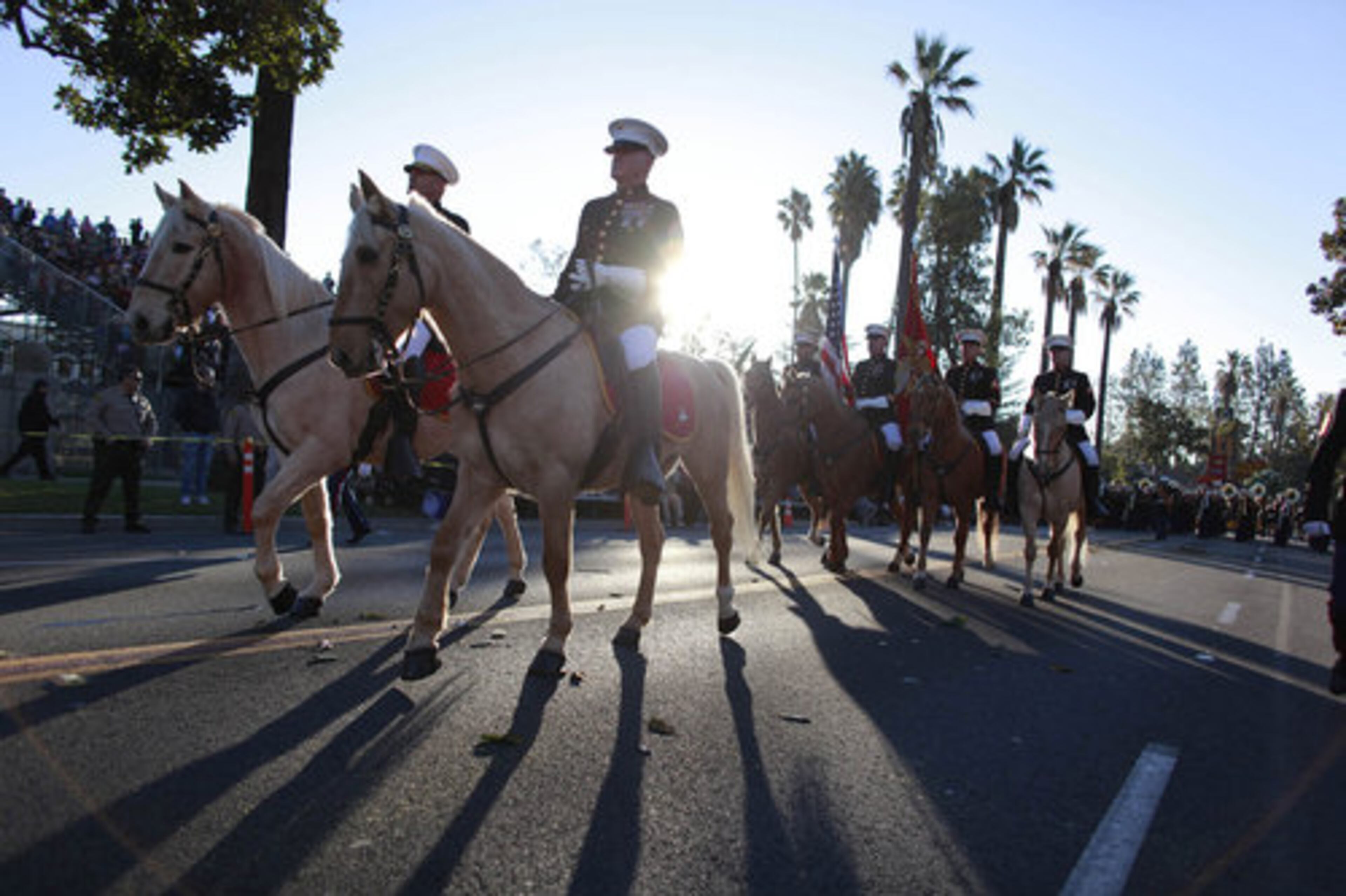 The Marine Corps Mounted Color Guard ride the palm-tree lined streets during the 123rd Rose Parade.