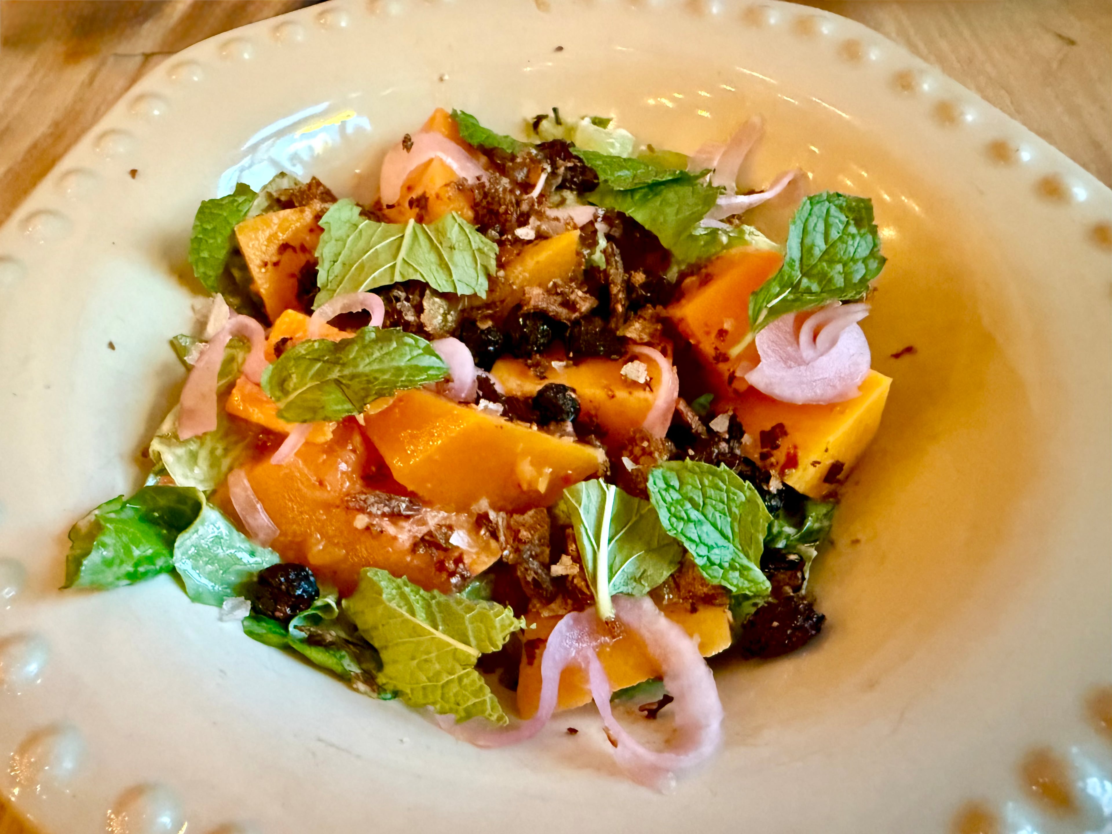 Roasted kabocha squash salad with savory trout skin spice at Summerhill’s Little Bear. (Angela Hansberger for the AJC)