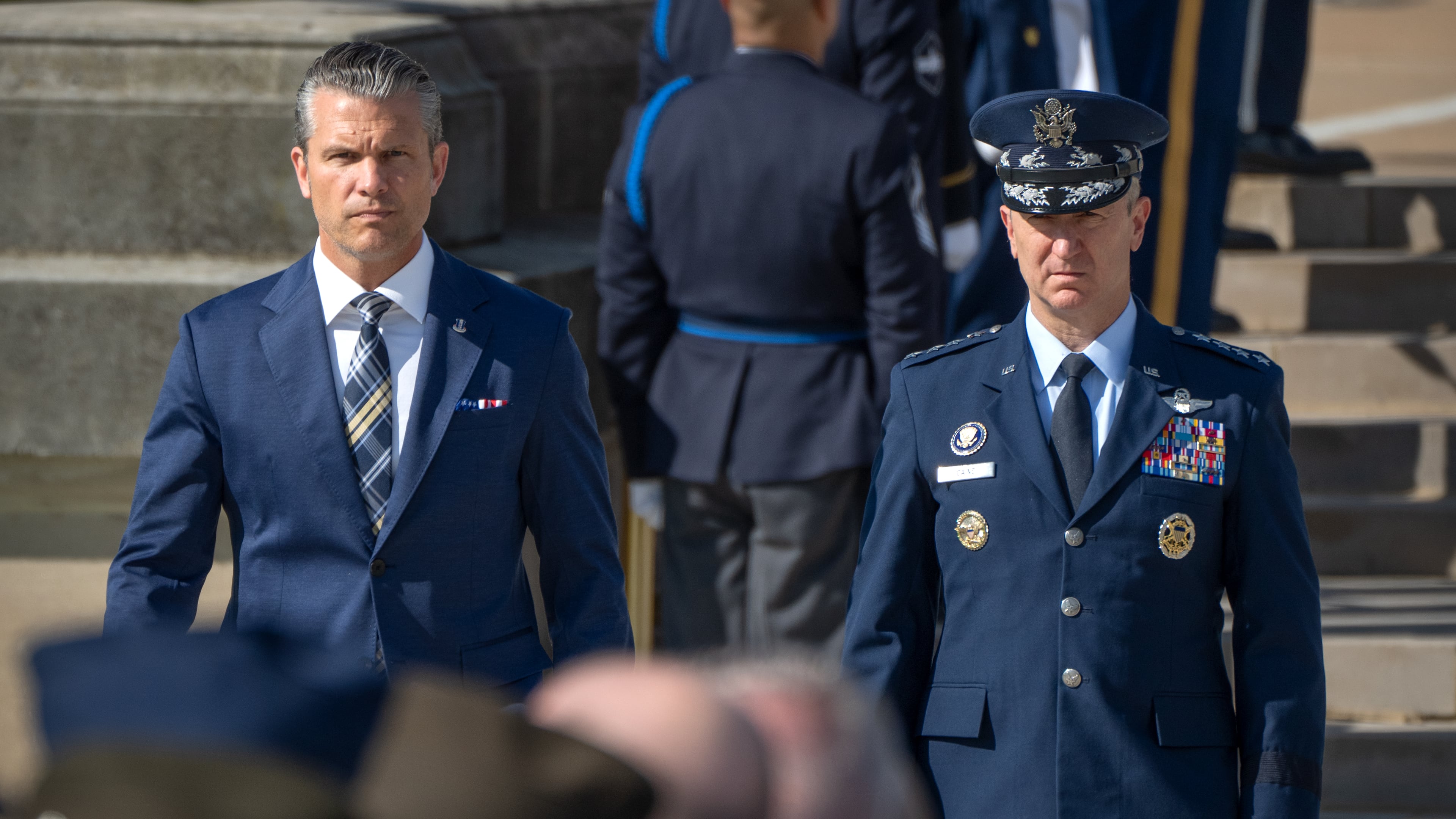 Defense Secretary Pete Hegseth, left, and Chairman of the Joint Chiefs of Staff Gen. Dan Caine, right, arrive for the POW/MIA National Recognition Day Ceremony at the Pentagon, Friday, Sept. 18, 2026, in Washington. (AP Photo/Mark Schiefelbein)