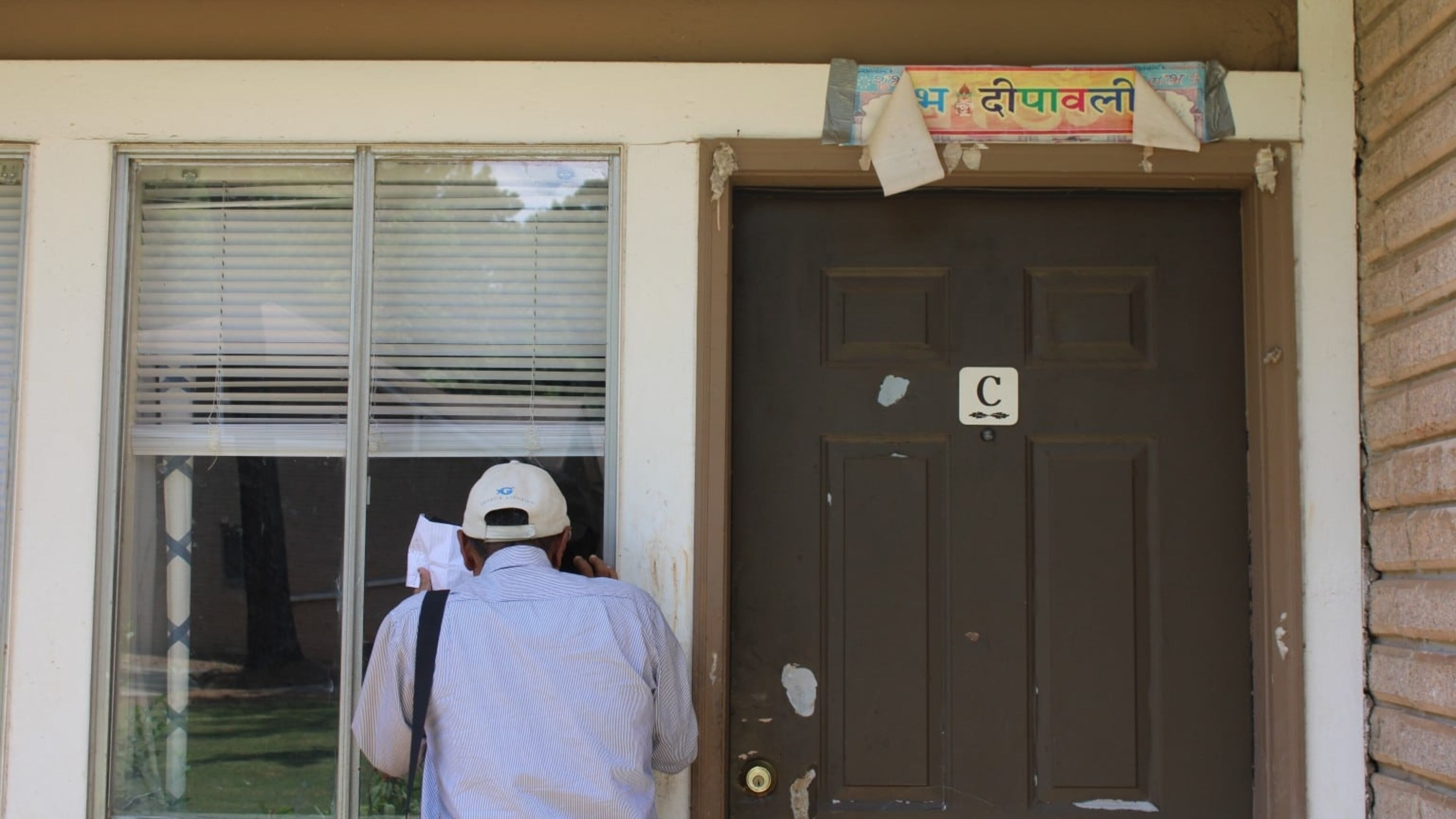 Birenda Dhakal, a community health worker with the Clarkston Community Health Clinic, visits a Bhutanese family at the English Oaks apartment complex. (Photo Courtesy of Sophia Qureshi)
