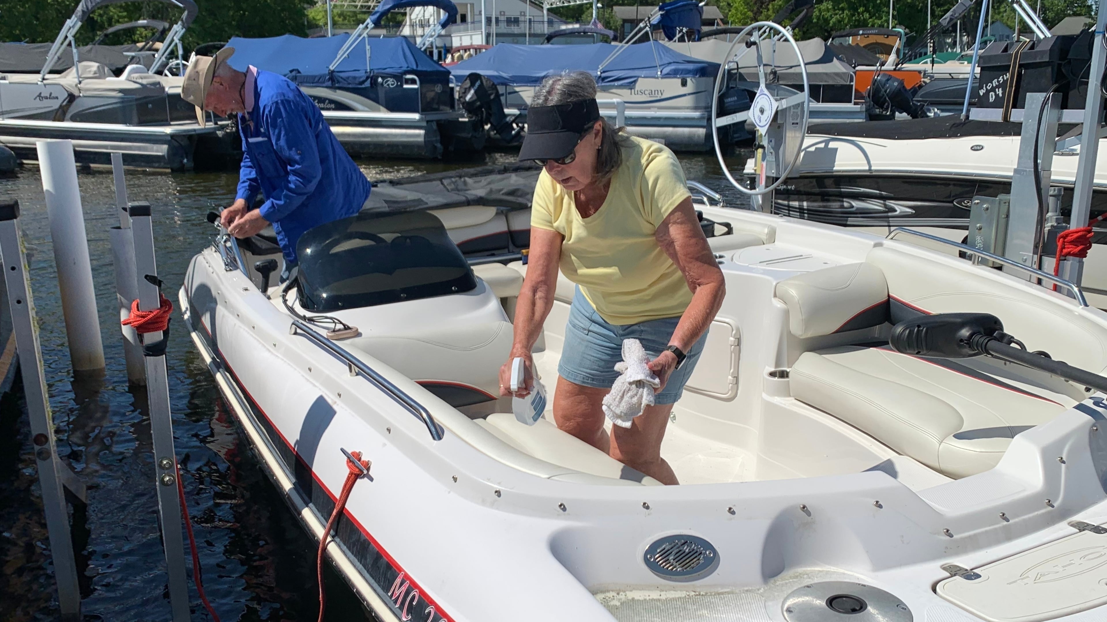 Kay Worsham cleans her boat Sunday, May 31, 2026, in Dexter Township, Mich. (AP Photo/Mike Householder)