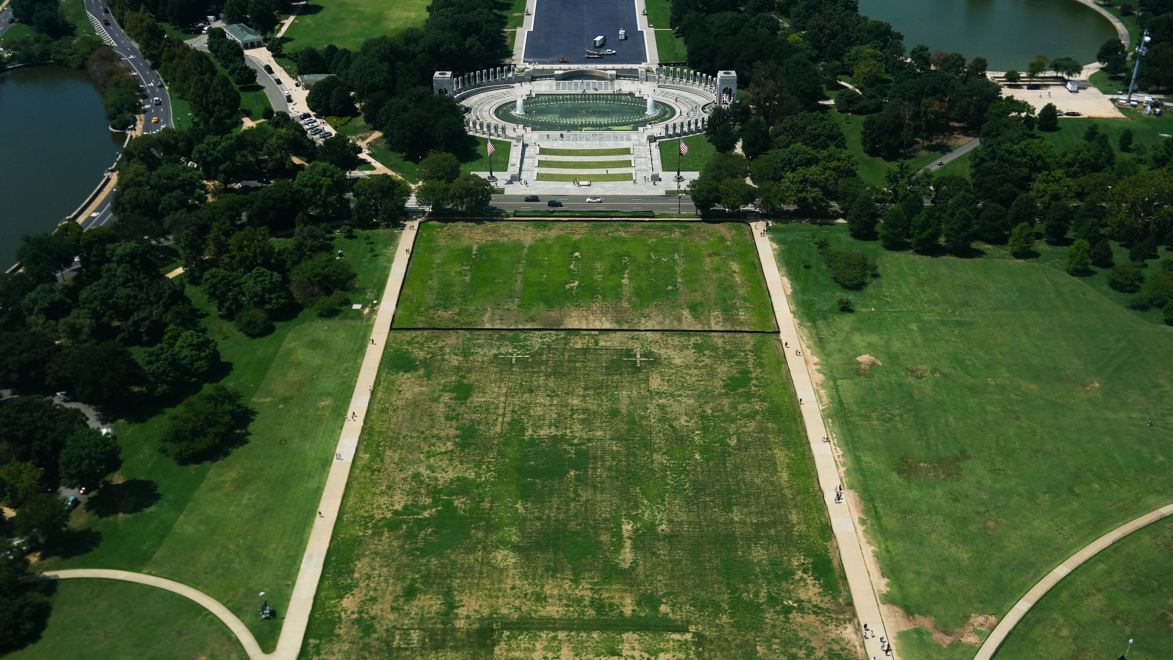 Damaged grass on the National Mall is seen from the Washington Monument, Monday, Aug. 17, 2026, in Washington, with the World War II Memorial in the background. (AP Photo/Julia Demaree Nikhinson)