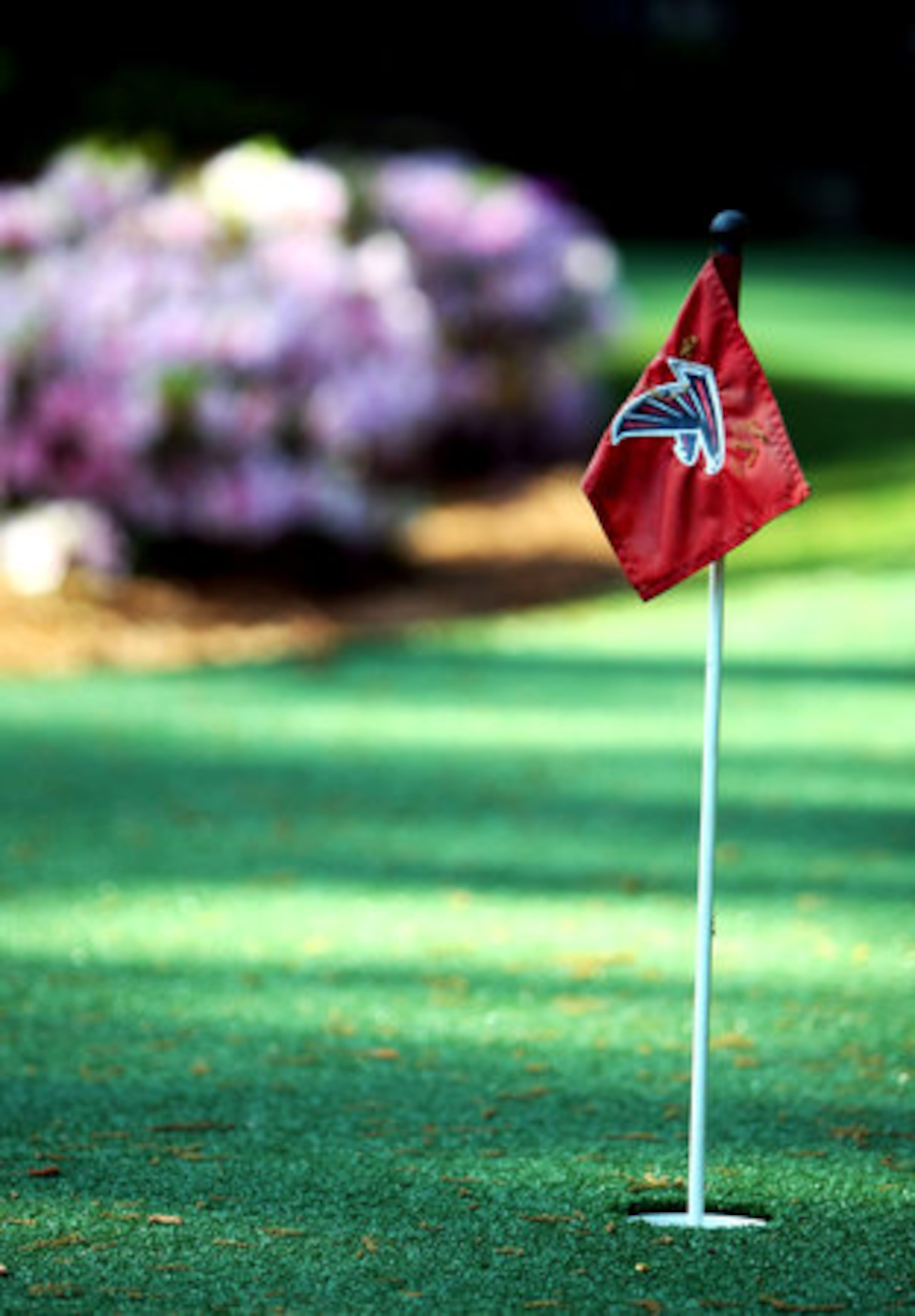 An Atlanta Falcon flag tops the cup on the putting green in the garden of Arthur Blank's Buckhead home. Blank is the owner of the Atlanta Falcons.
