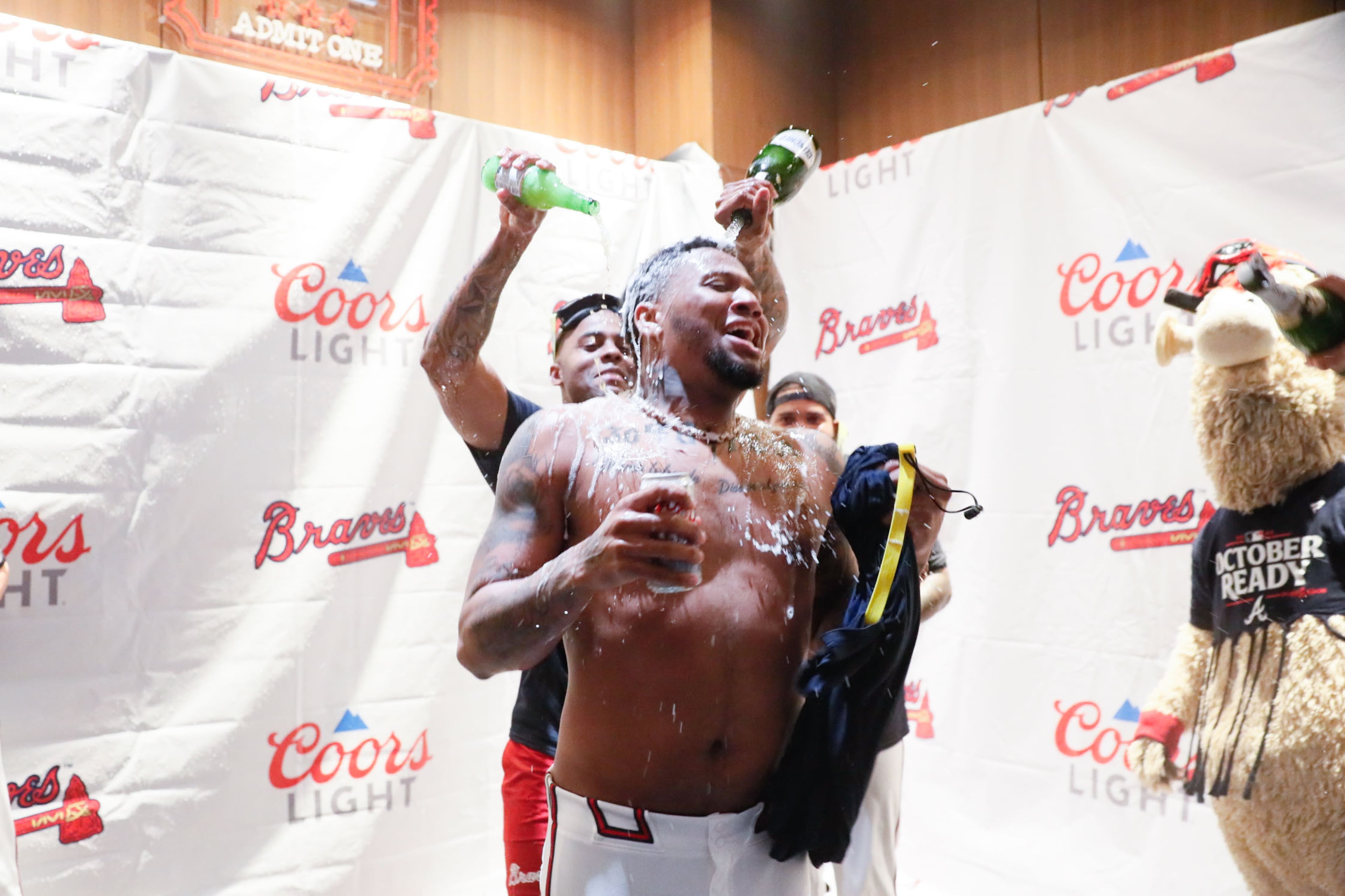 Ronald Acuña Jr. gets a shower of champagne after the Braves defeated the Mets in the second game.
(Miguel Martinez/ AJC)