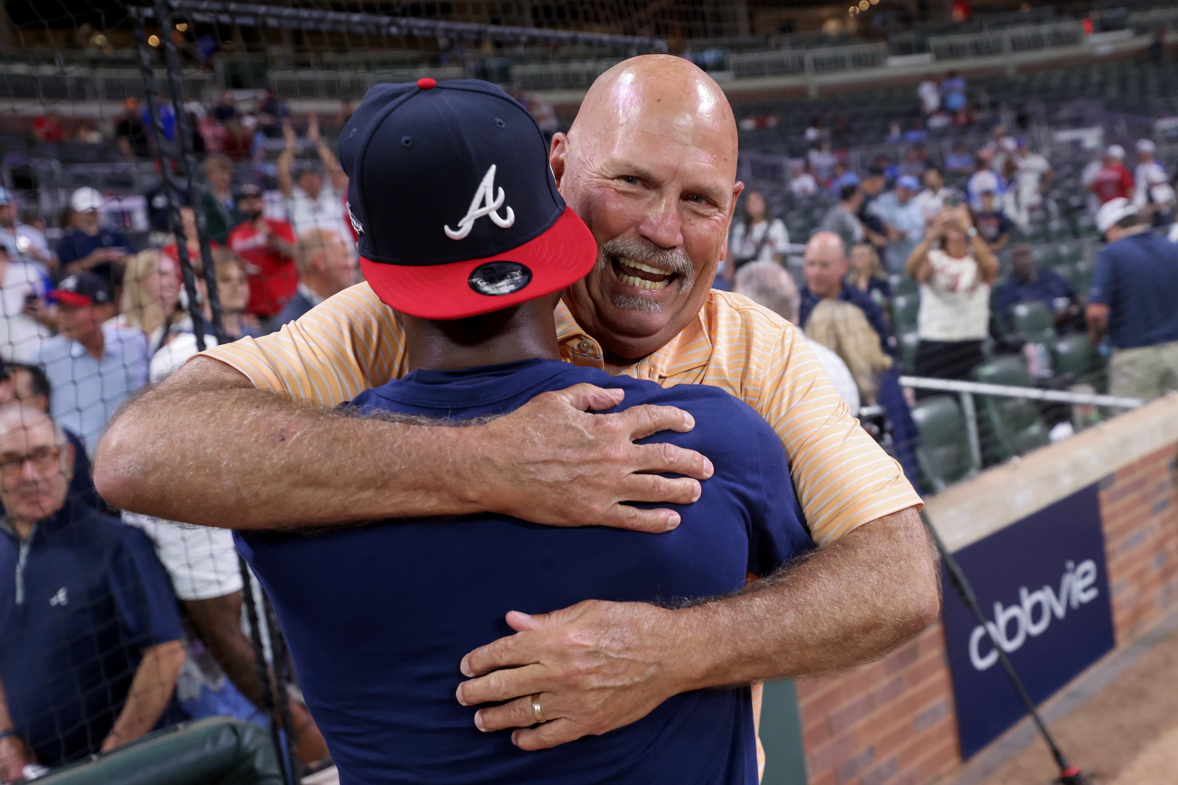 Braves second baseman Ozzie Albies (left) celebrates with former manager Brian Snitker on the field after defeating the Phillies to win their NL Wild Card Series on Thursday, Oct. 1, 2026, in Atlanta. (Jason Getz/AJC)