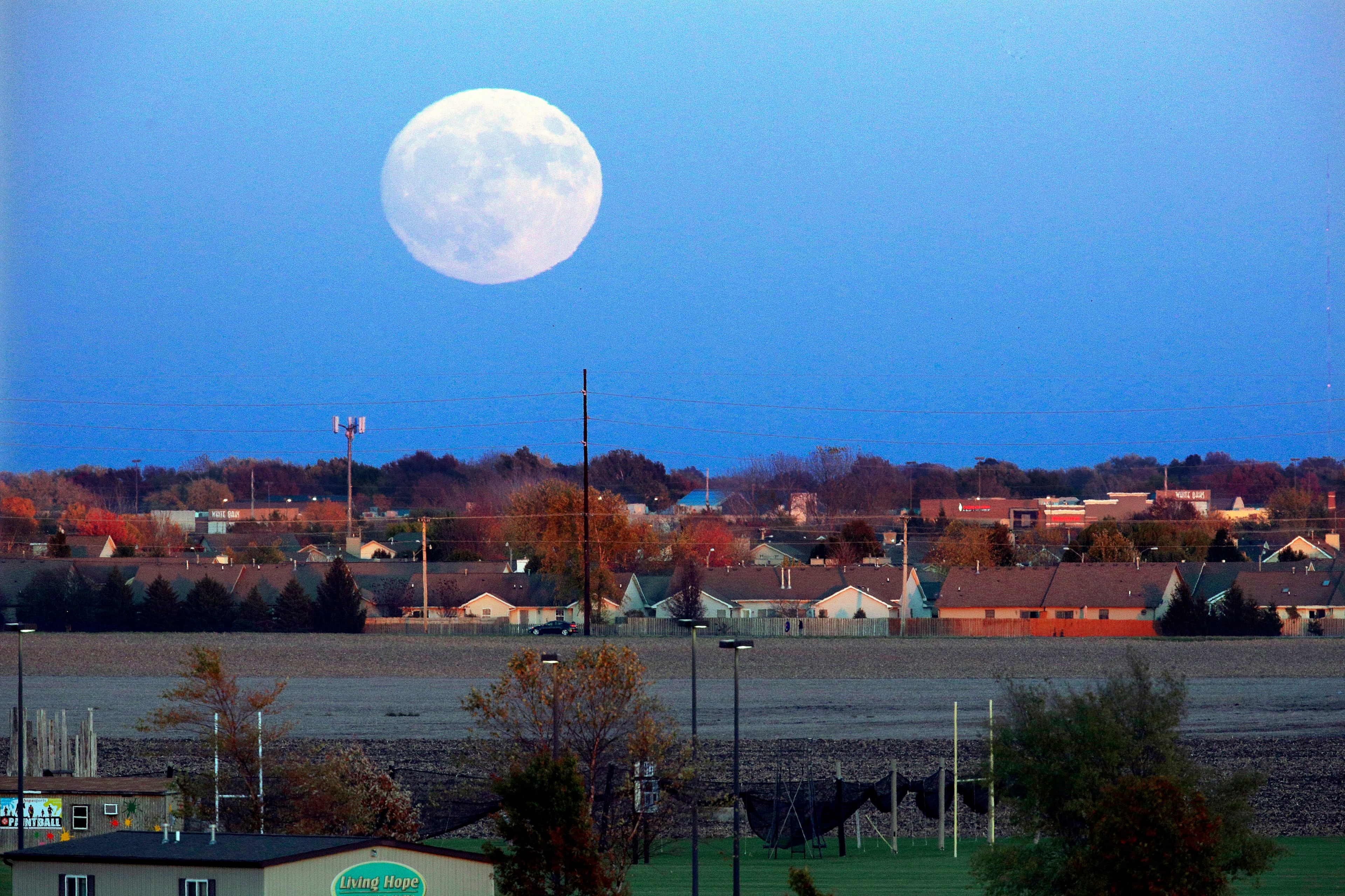 The moon rises beyond Springfield, Ill., Sunday, Nov. 13, 2016. On Monday the supermoon will be the closest full moon to earth since 1948, and it won't be as close again until 2034. (AP Photo/Seth Perlman)