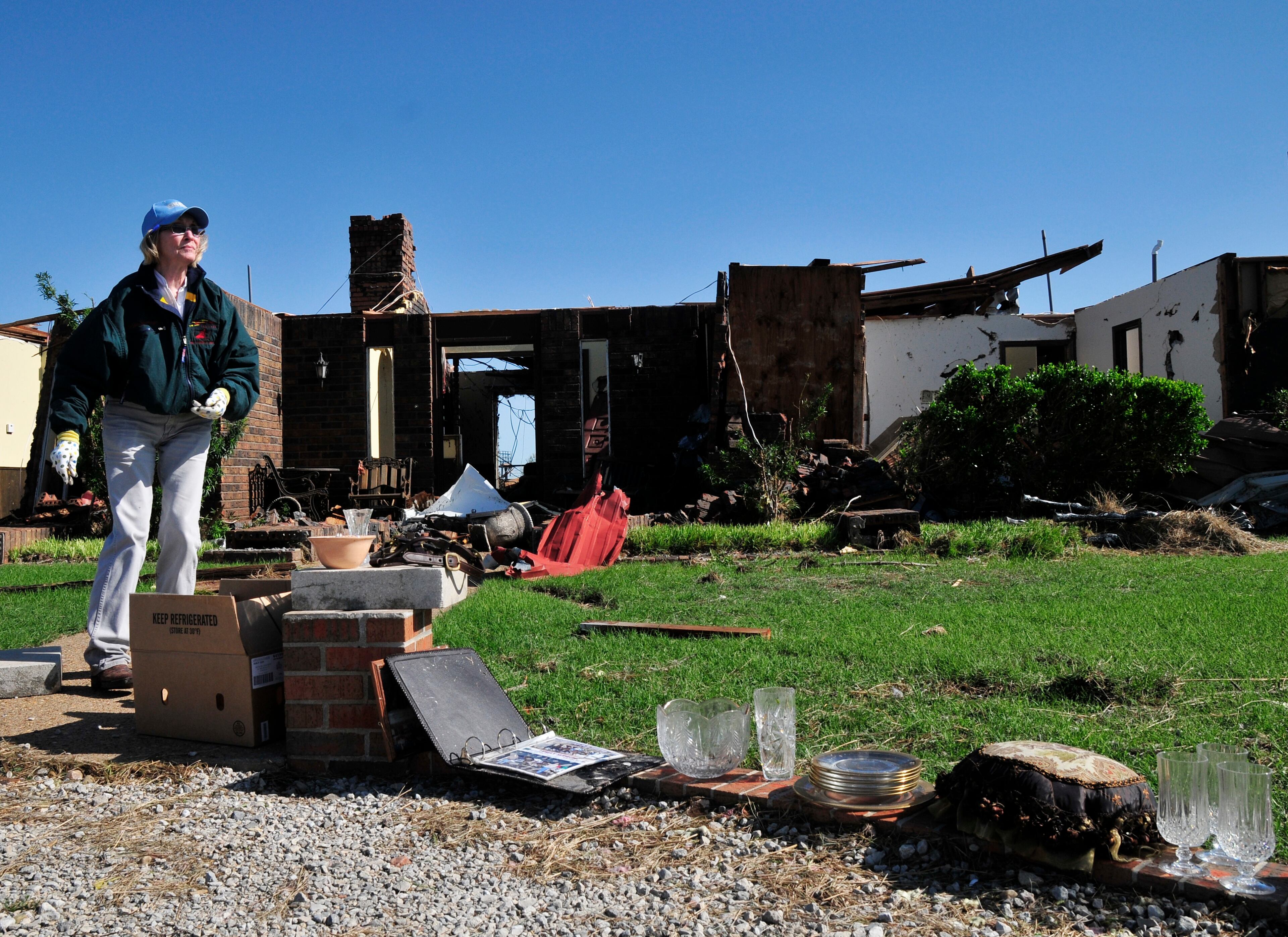 Bobbie Steenbergen walks outside of what is left of her home that was destroyed by the tornado that swept through Central Oklahoma Friday afternoon on Saturday June 1, 2013 in El Reno Okla. Emergency officials set out Saturday morning to see how much damage a violent burst of thunderstorms and tornadoes caused as it swept across the Midwest overnight. (AP Photo/Nick Oxford)