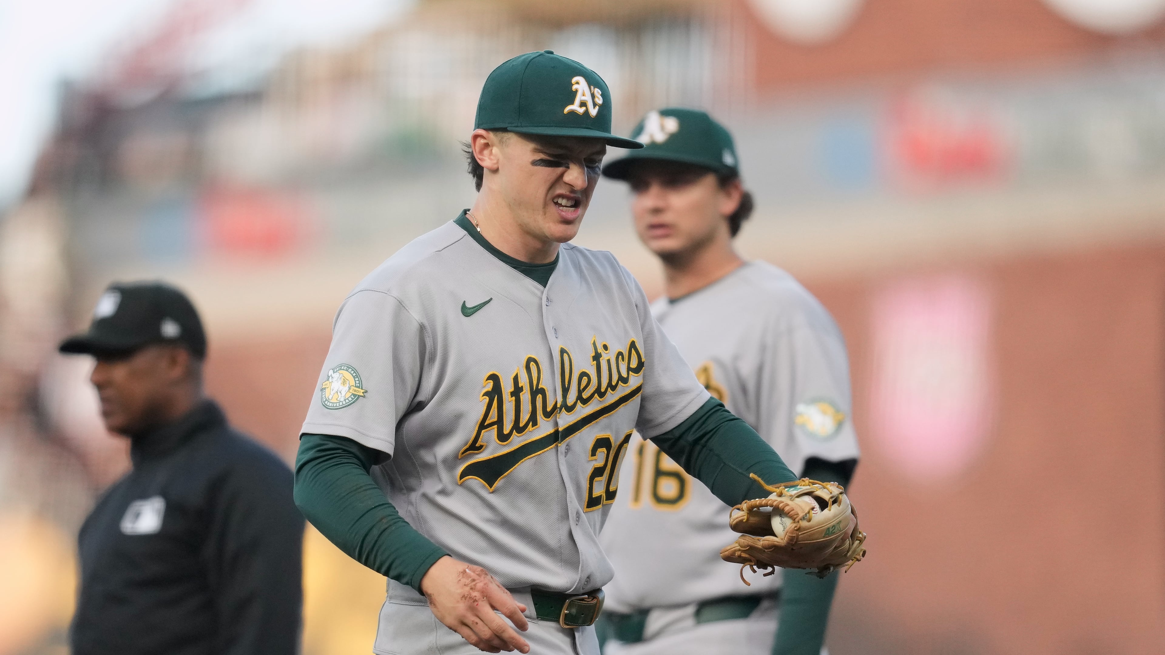 Athletics second baseman Zack Gelof, left, reacts as he walks off the field during the second inning of a baseball game against the San Francisco Giants Tuesday, June 23, 2026, in San Francisco. (AP Photo/Jeff Chiu)