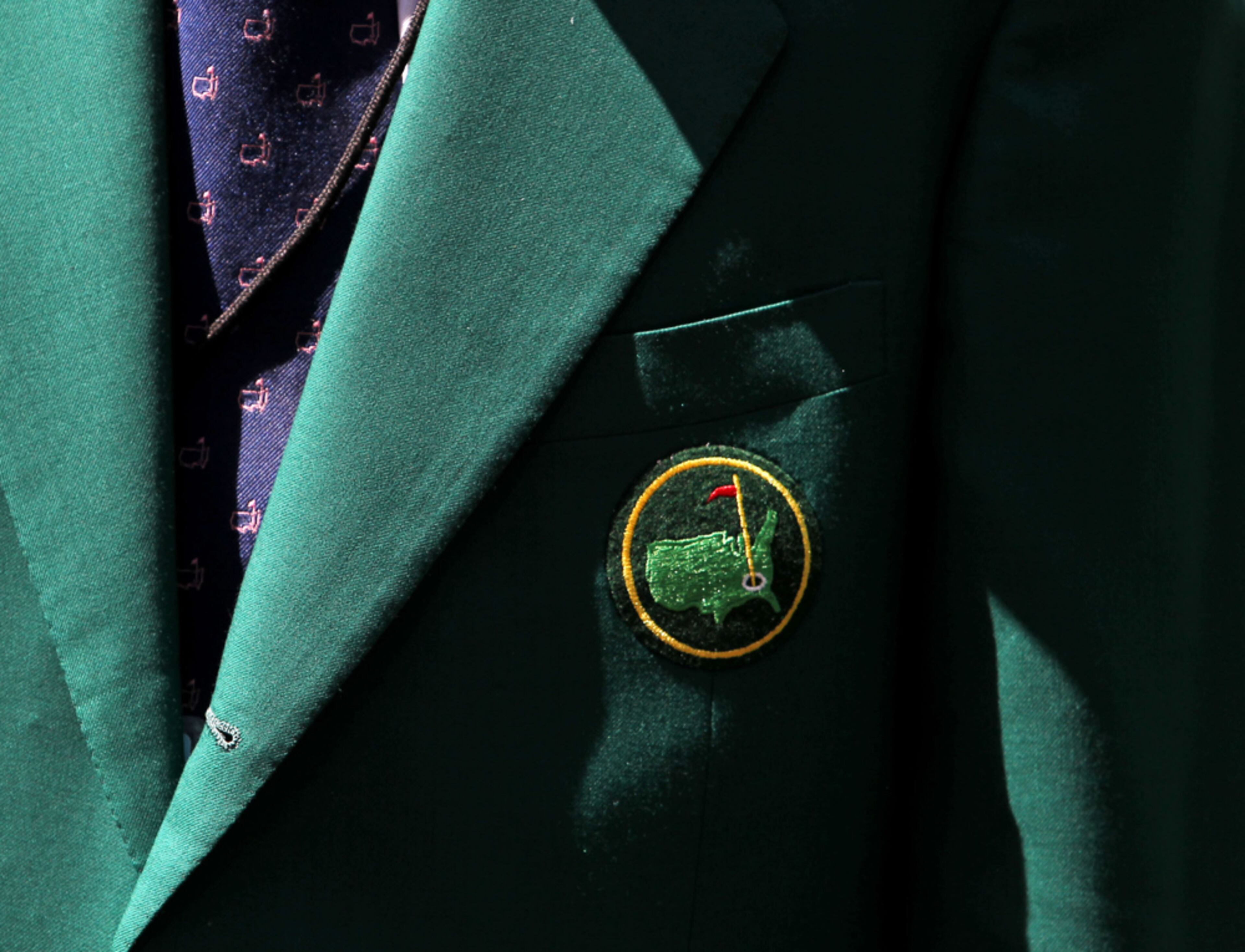 April 10, 2013 - Augusta, Ga: Augusta National member John Dobbs wears his green jacket as he helps out on the No. 4 green during the Par Three Competition the day before the 2013 Masters at Augusta National Golf Club Wednesday afternoon in Augusta, Ga., April 10, 2013. Getz said, "I normally don't chose images like this but I like the simplicity of the green jacket that's so well known at the Masters." JASON GETZ / JGETZ@AJC.COM