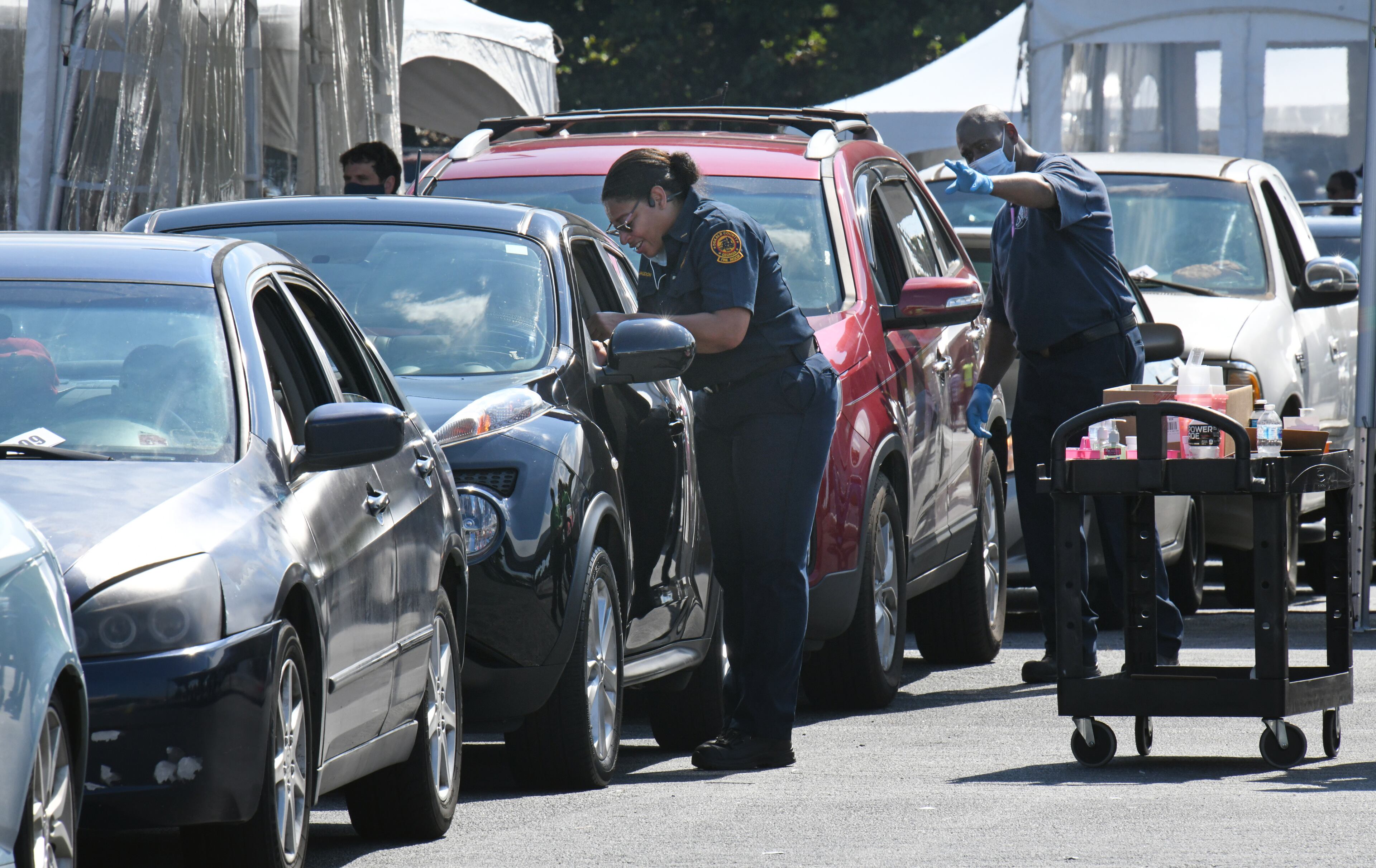A representative from DeKalb County Fire Rescue administers a COVID-19 vaccination during an event at The Gallery at South DeKalb on Saturday, August 13, 2021. DeKalb County gave out $100 prepaid debit cards to people who got a shot. (Hyosub Shin / Hyosub.Shin@ajc.com)