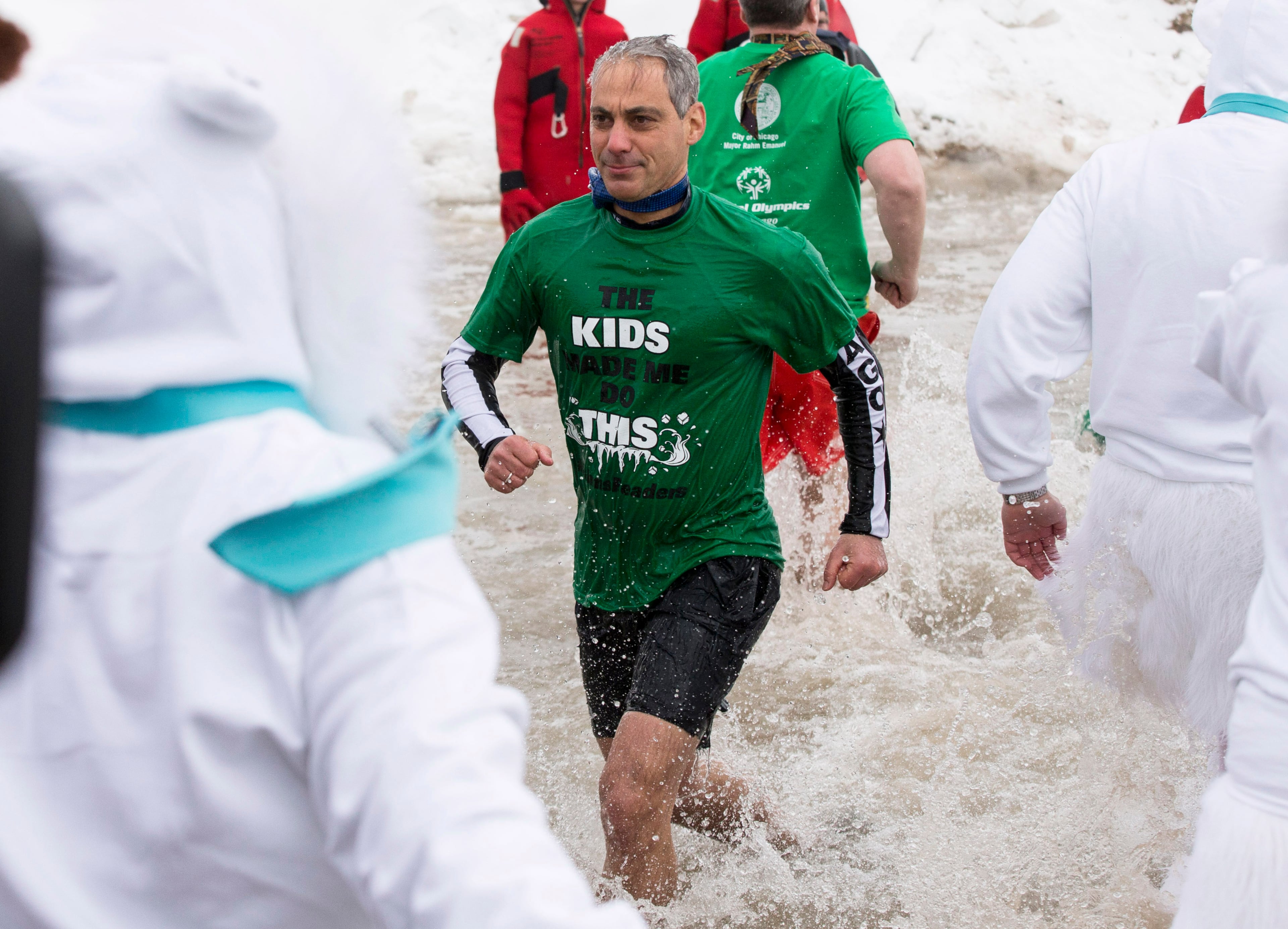 Chicago Mayor Rahm Emanuel exits the water during the Chicago Polar Plunge, Sunday, March 2, 2014, in Chicago. Emanuel, wearing a green Chicago Public Library T-shirt and shorts, went first, with Fallon just after. Both fled the water to cheers from a large crowd. KERRY LESTER (AP Photo/Andrew A. Nelles)