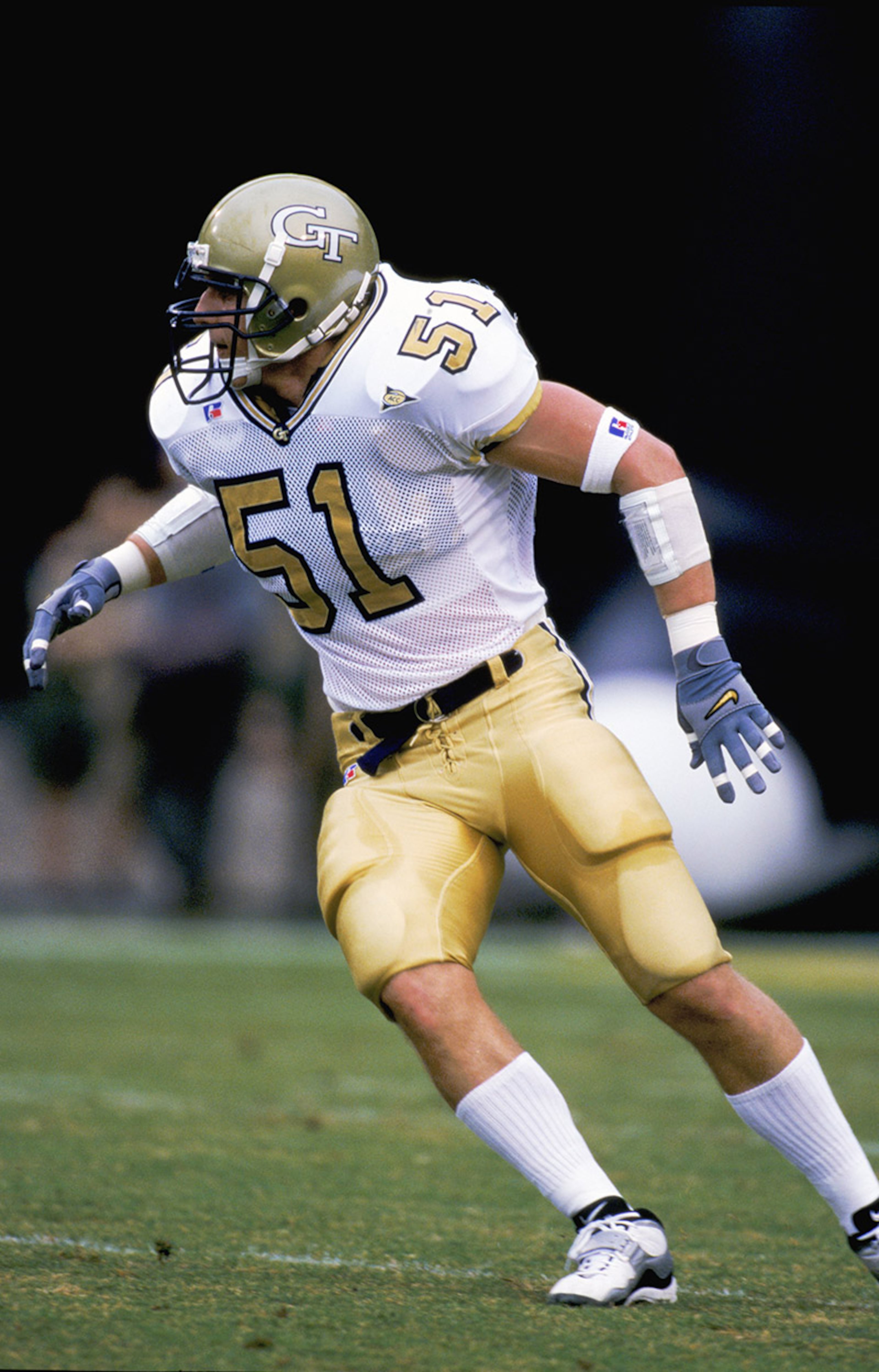 Tech resumed wearing white jerseys, gold pants and gold helmets, home and away, in 1995. Here is a version of that combination in a 1999 game.