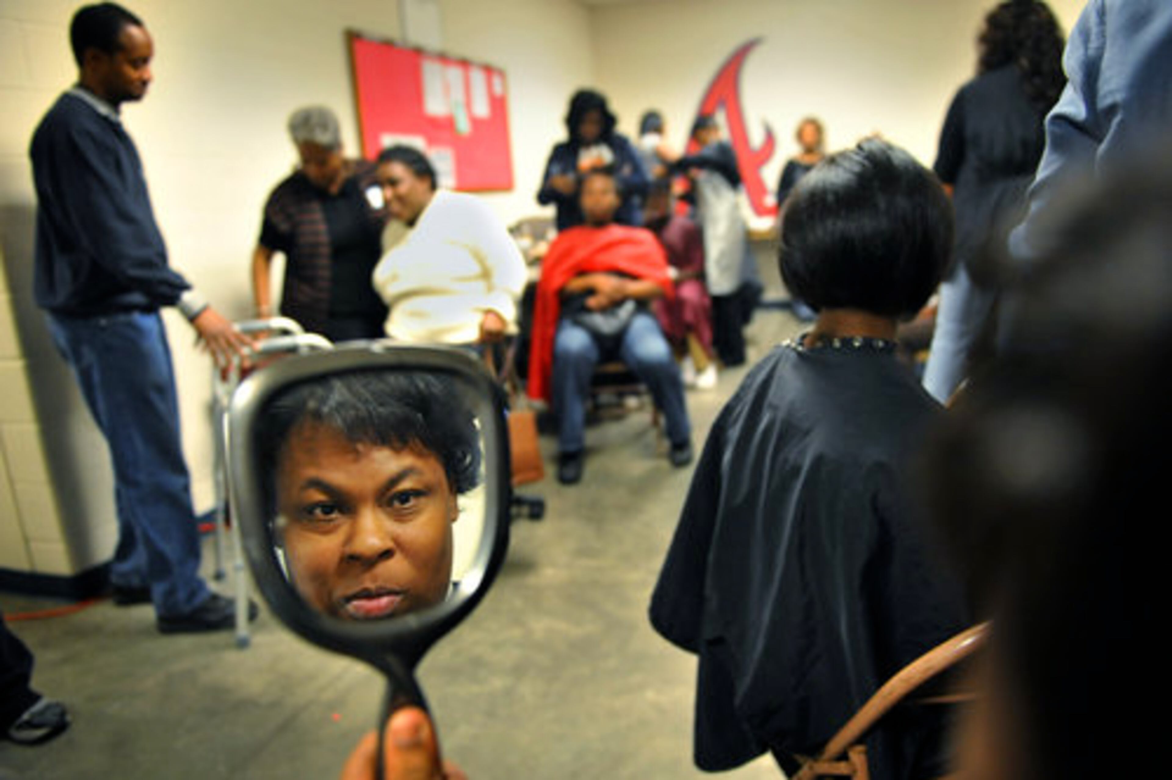 In addition to the meal, attendees were offered services that ranged from a barber and beauty shop to hot showers and medical check-ups. Dede Cook, 35, of Atlanta took advantage of the salon, admiring the finished product in a hand mirror.