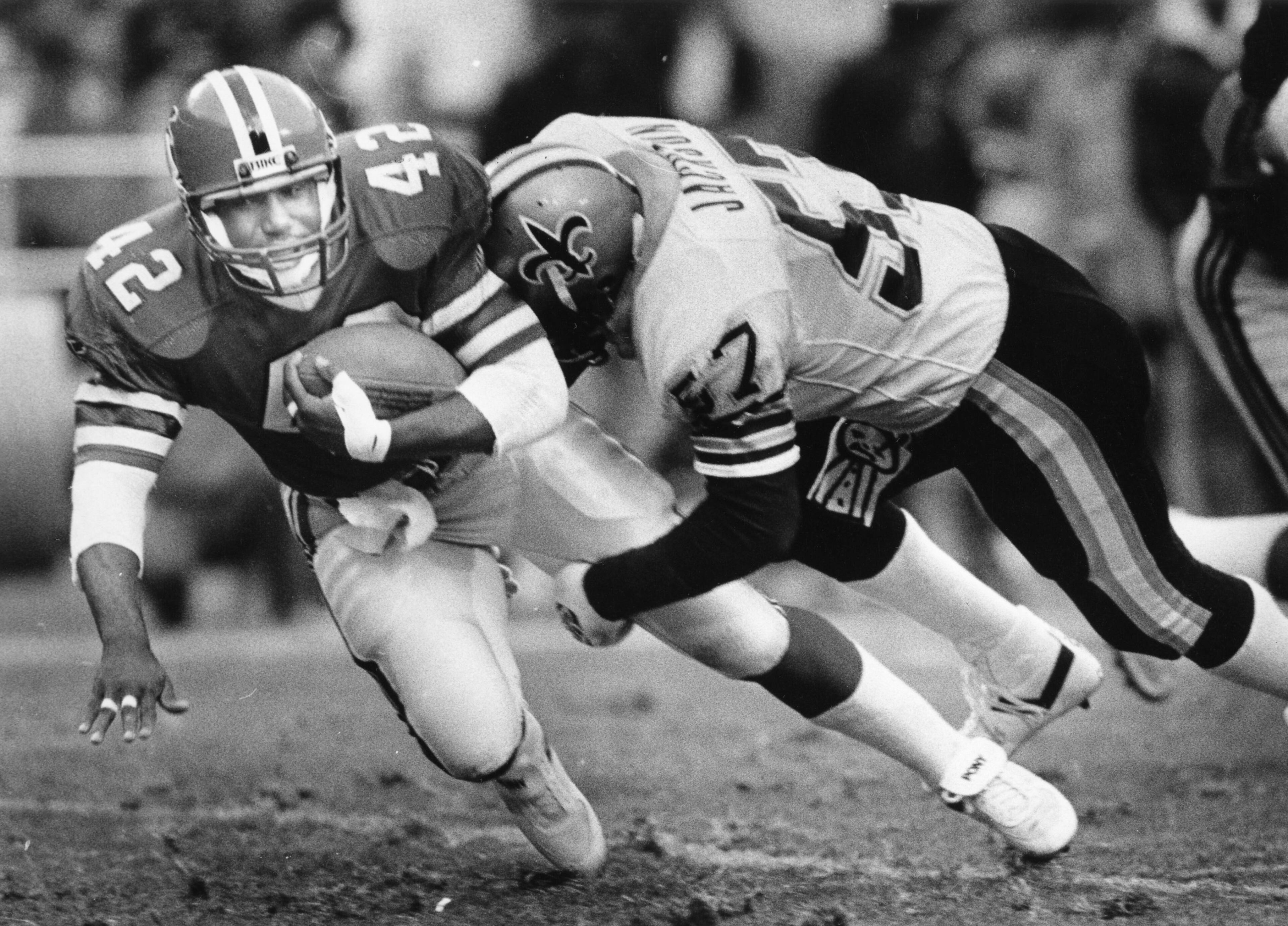 Riggs (left) gets hit by the Saints' Rickey Jackson. Andy Sharp / AJC