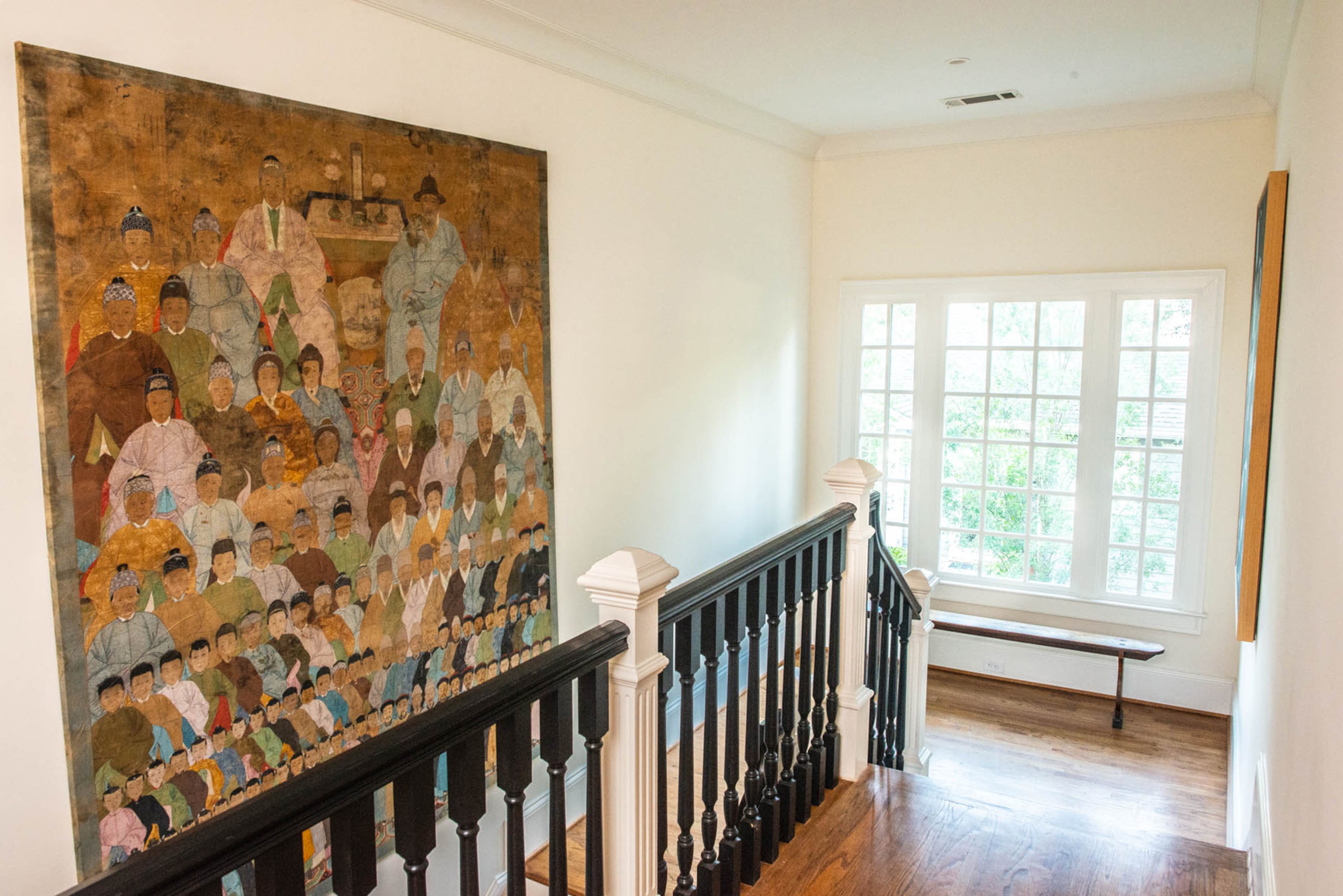 A Chinese ancestor painting dominates the stairway and upstairs landing in the Buckhead home.