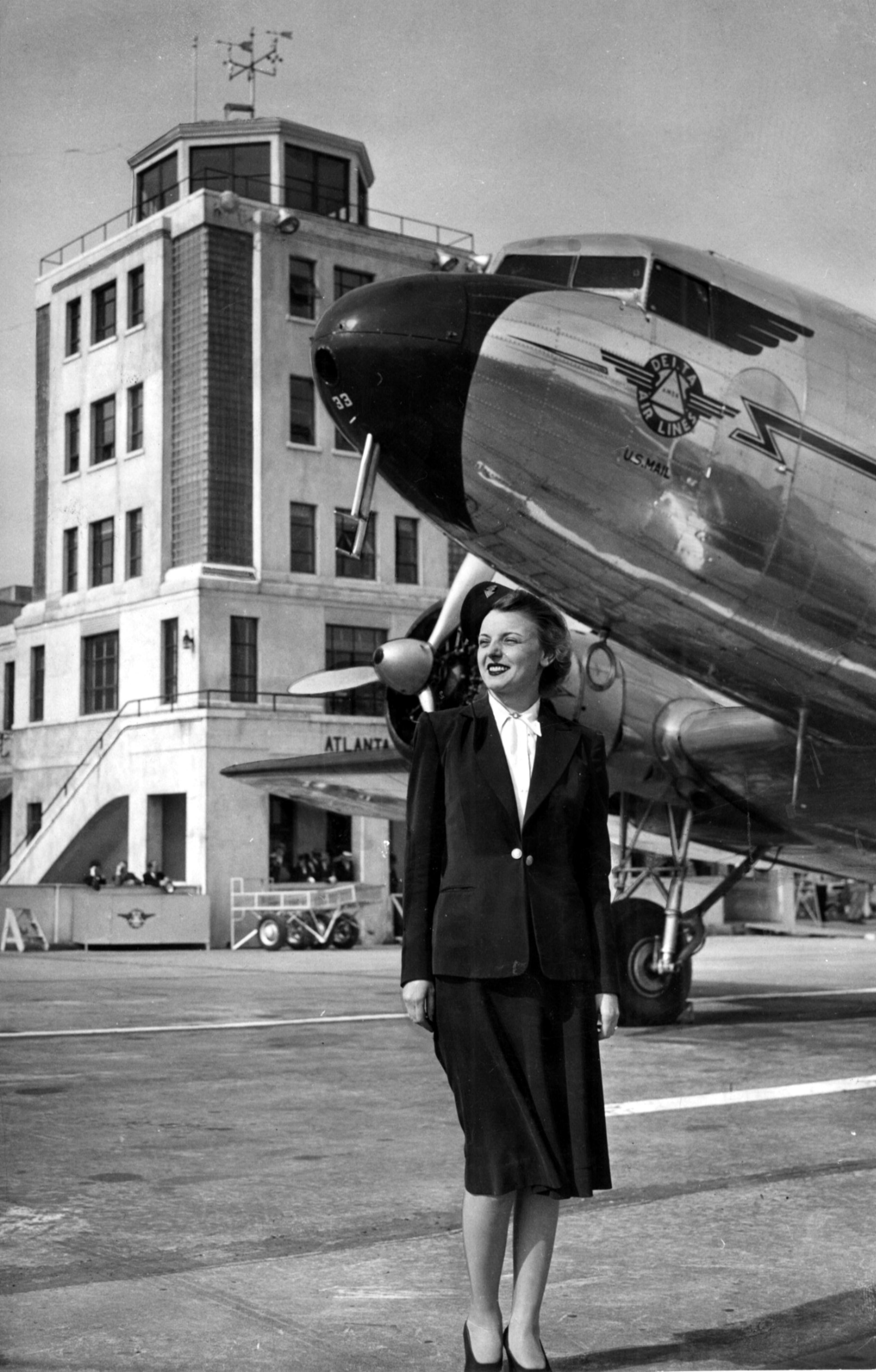 Dec. 1940 - Atlanta, Ga.: Delta Air Lines Chief Stewardess Laura Wizark stands before one of the fleet's planes. By 1940, Delta had been servicing Atlanta for 10 years.