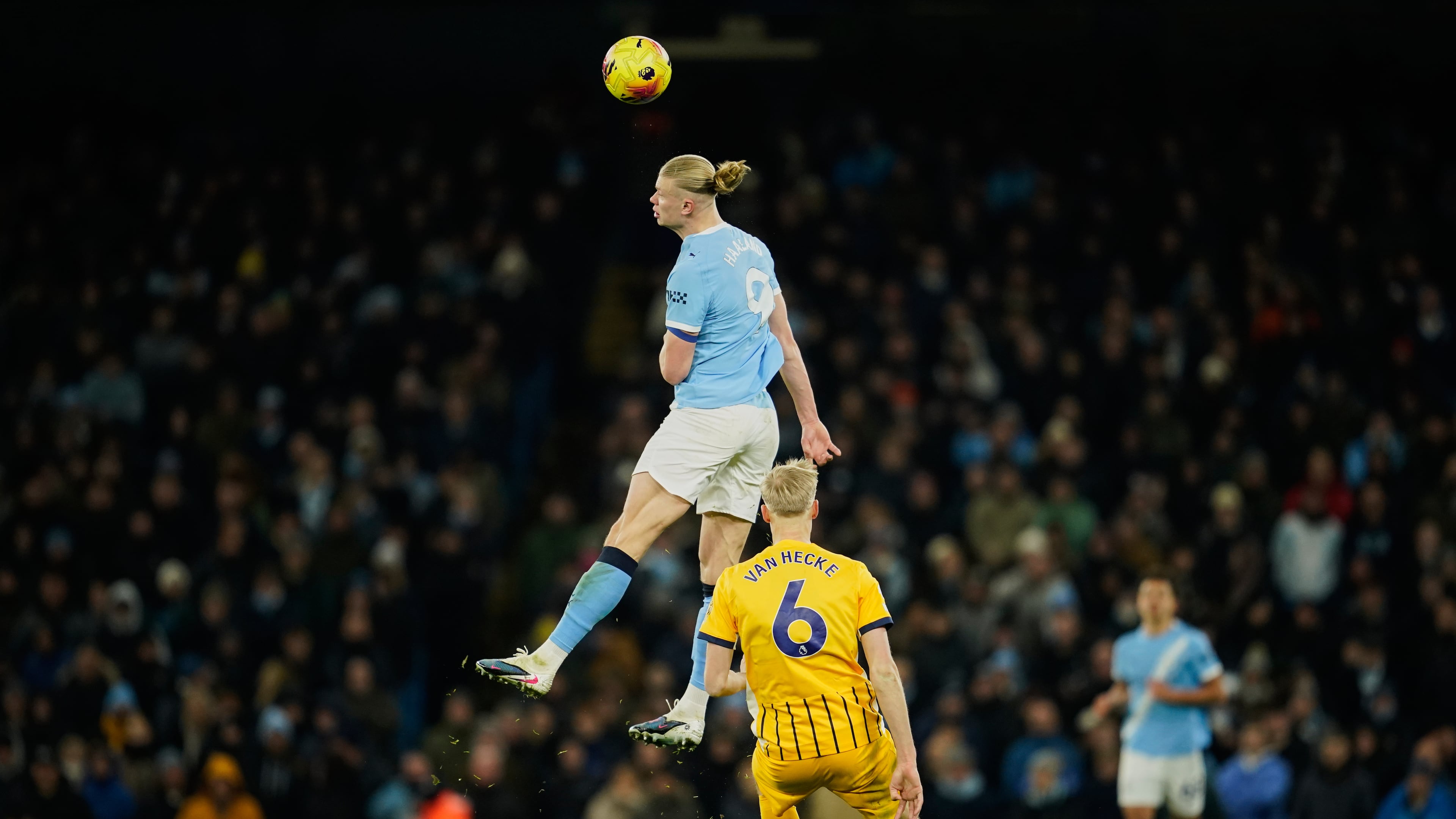 Manchester City's Erling Haaland, top, heads the ball past Brighton's Jan Paul van Hecke during the English Premier League soccer match between Manchester City and Brighton and Hove Albion in Manchester, England, Wednesday, Jan. 7, 2026. (AP Photo/Dave Thompson)