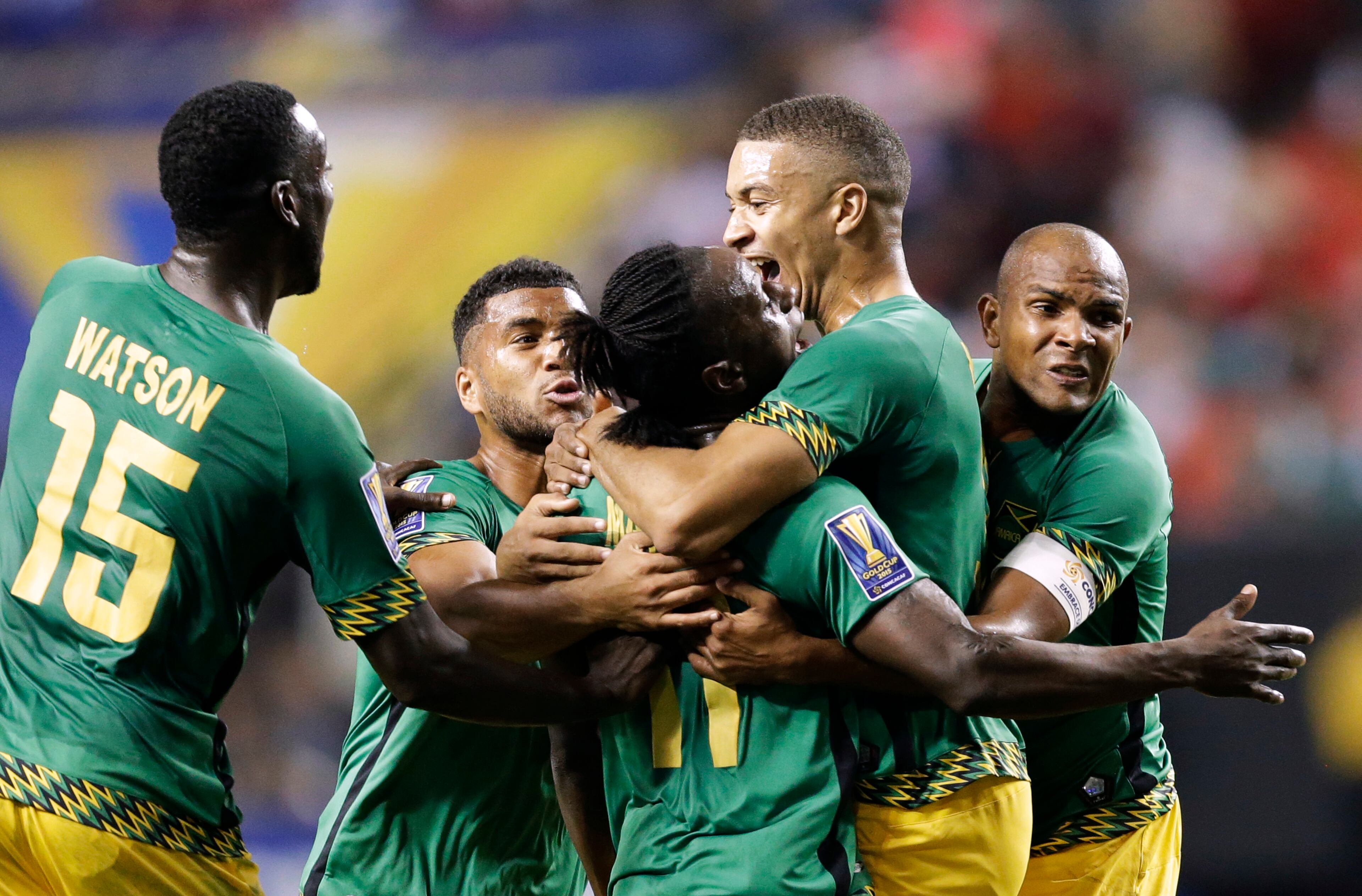 Jamaica's Darren Mattocks, center, is embraced by teammate Michael Hector, right, after Mattocks scored a goal during the first half of a CONCACAF Gold Cup soccer semifinal against the United States on Wednesday, July 22, 2015, in Atlanta. (AP Photo/David Goldman)
