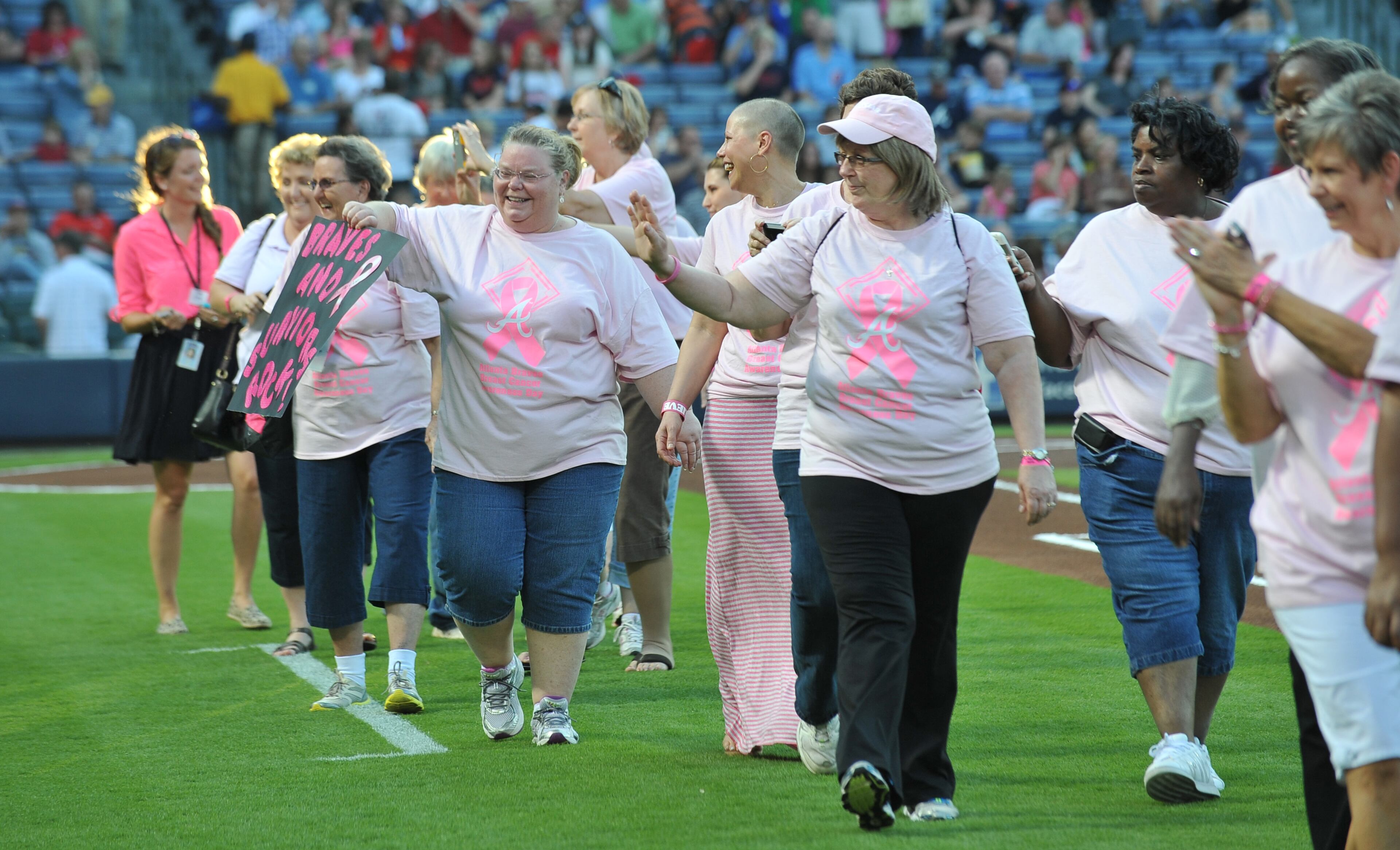 About 300 survivors and their families marched on field during "A Walk in the Park," a pregame ceremony before Atlanta Braves game against the San Diego Padres at Turner Field on Saturday, September 14, 2013. This season, the Braves, WellStar Health System, Kroger and the American Cancer Society Making Strides Against Breast Cancer teamed up for the 7th annual Braves Breast Cancer Awareness Day. The day-long celebration of survivorship honors those who have courageously battled breast cancer, and raised awareness and funds to support research, education and advocacy for cancer patients and their families throughout metro Atlanta.