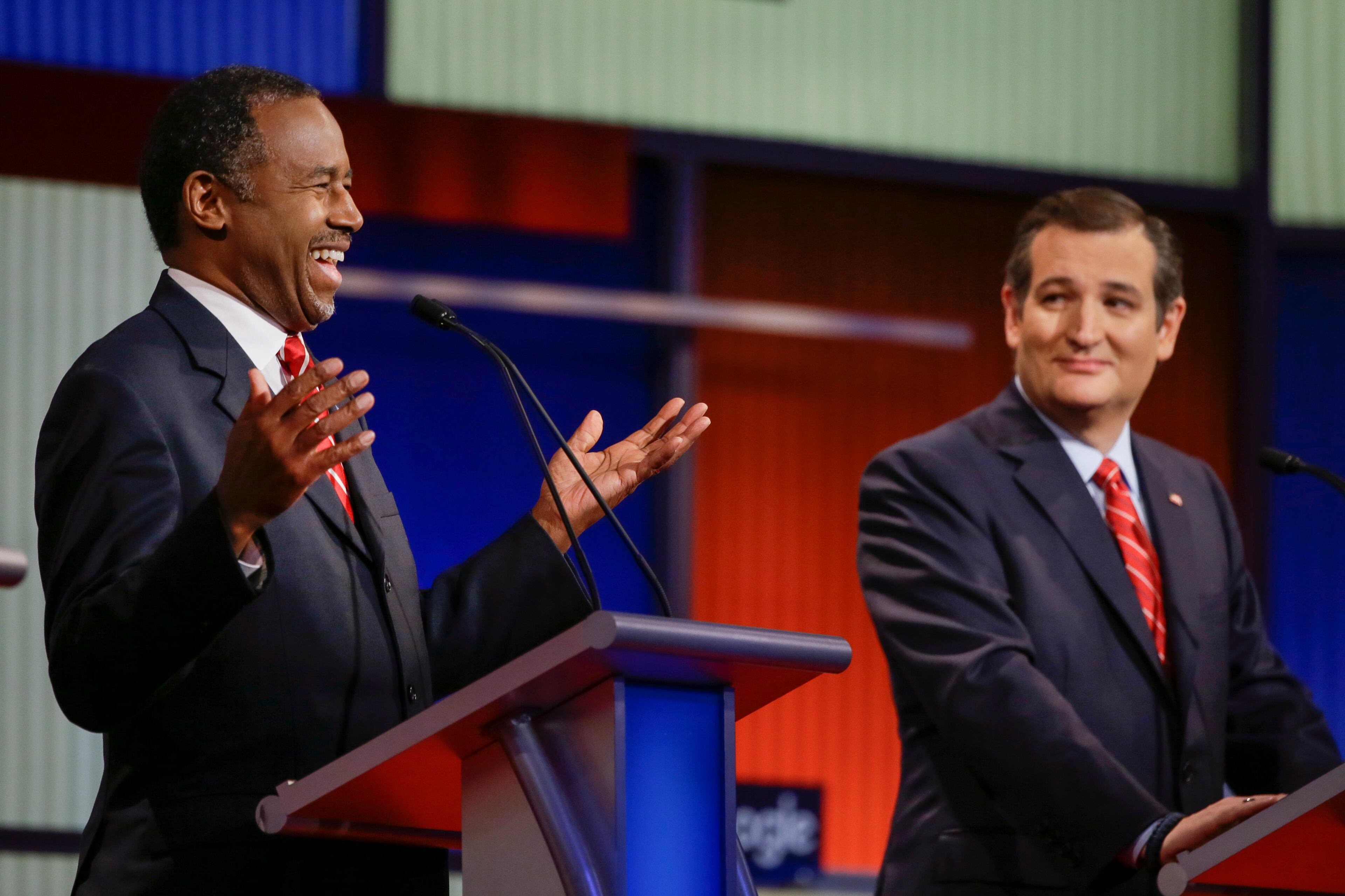 Republican presidential candidate retired neurosurgeon Ben Carson answers a question as Sen. Ted Cruz, R-Texas, looks on during a Republican presidential primary debate, Thursday, Jan. 28, 2016, in Des Moines, Iowa. (AP Photo/Charlie Neibergall)