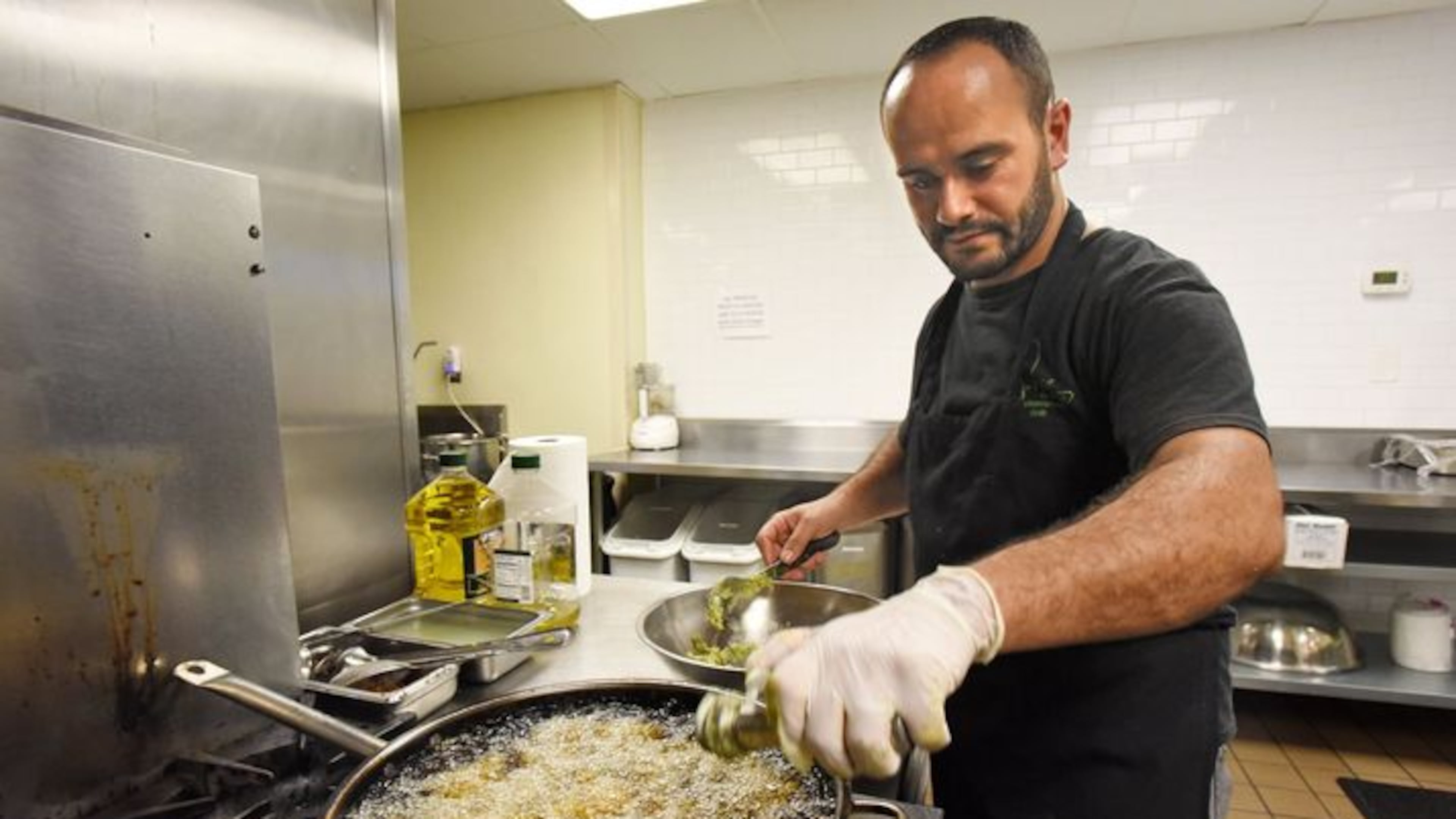 Samer, a Syrian refugee who asked that his last name not be published, makes falafel in a Mediterranean restaurant in downtown Atlanta. The war caused him to flee with his wife and newborn son to Jordan. HYOSUB SHIN / HSHIN@AJC.COM