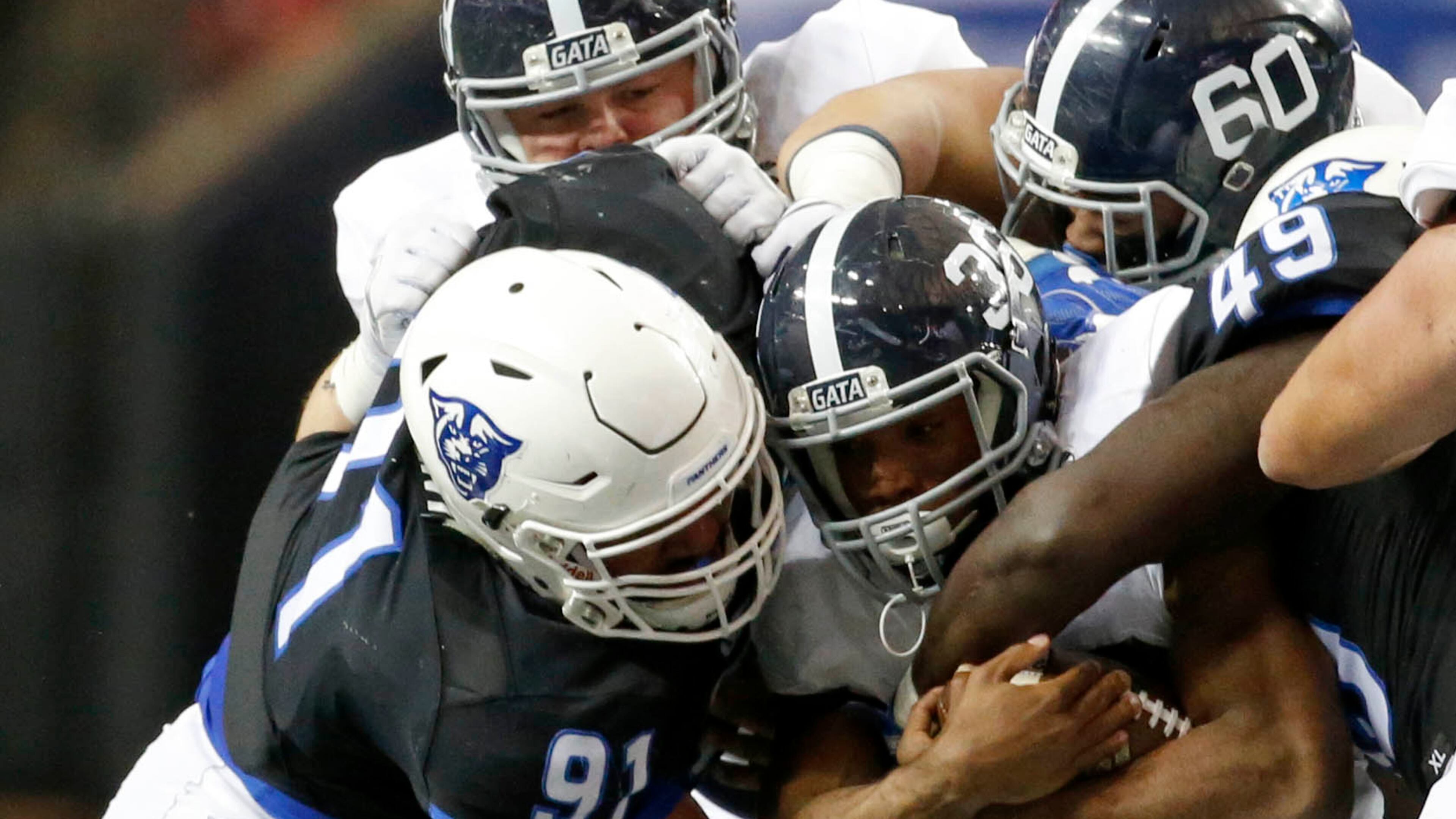 November 19, 2016 - Atlanta, Ga: Georgia State Panthers defensive lineman Julien Laurent (91) tackles Georgia Southern Eagles running back Matt Breida (36) after a short run in the second half of their game at the Georgia Dome Saturday November 19, 2016, in Atlanta, Ga. Georgia State won 30-24. PHOTO / JASON GETZ