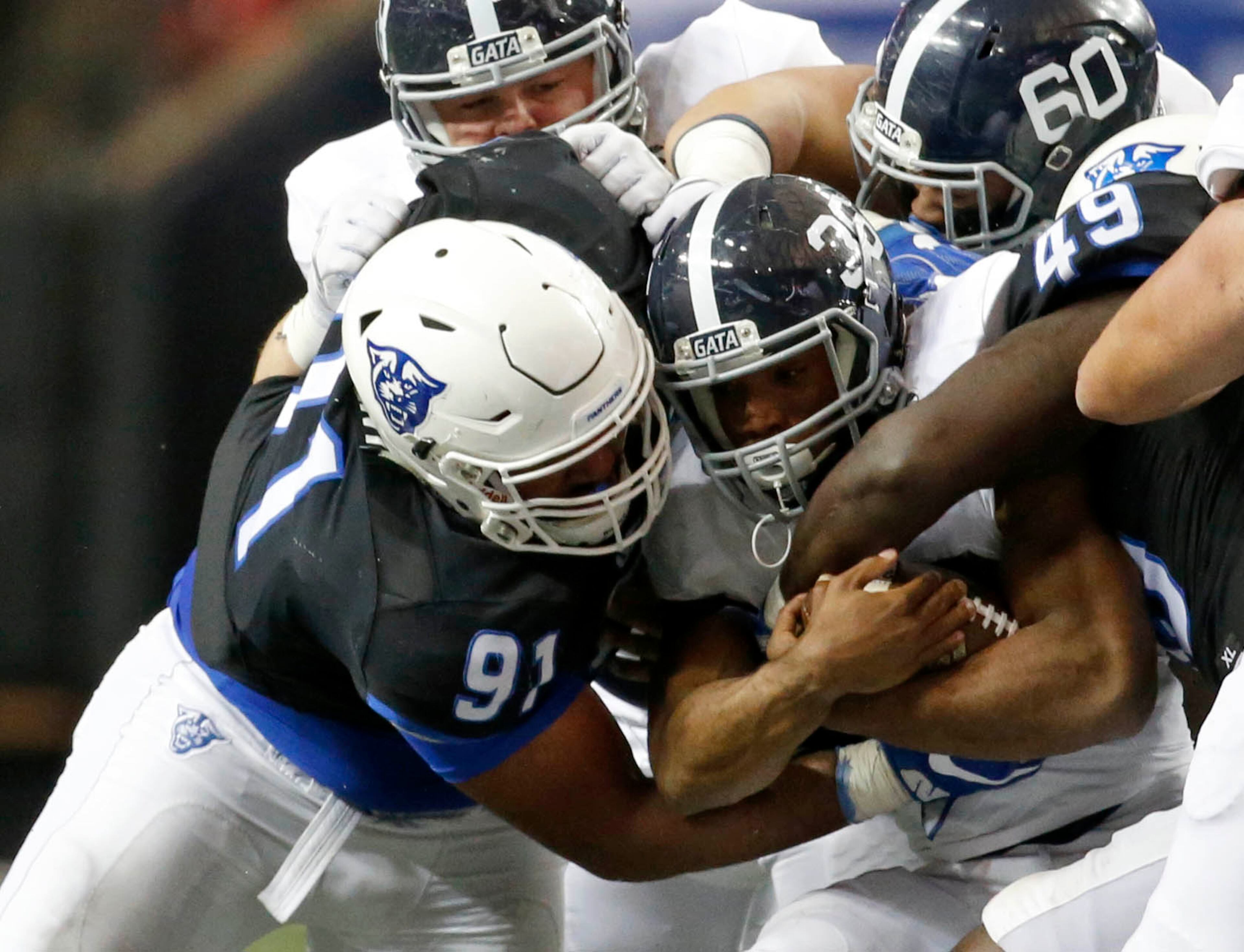 November 19, 2016 - Atlanta, Ga: Georgia State Panthers defensive lineman Julien Laurent (91) tackles Georgia Southern Eagles running back Matt Breida (36) after a short run in the second half of their game at the Georgia Dome Saturday November 19, 2016, in Atlanta, Ga. Georgia State won 30-24. PHOTO / JASON GETZ