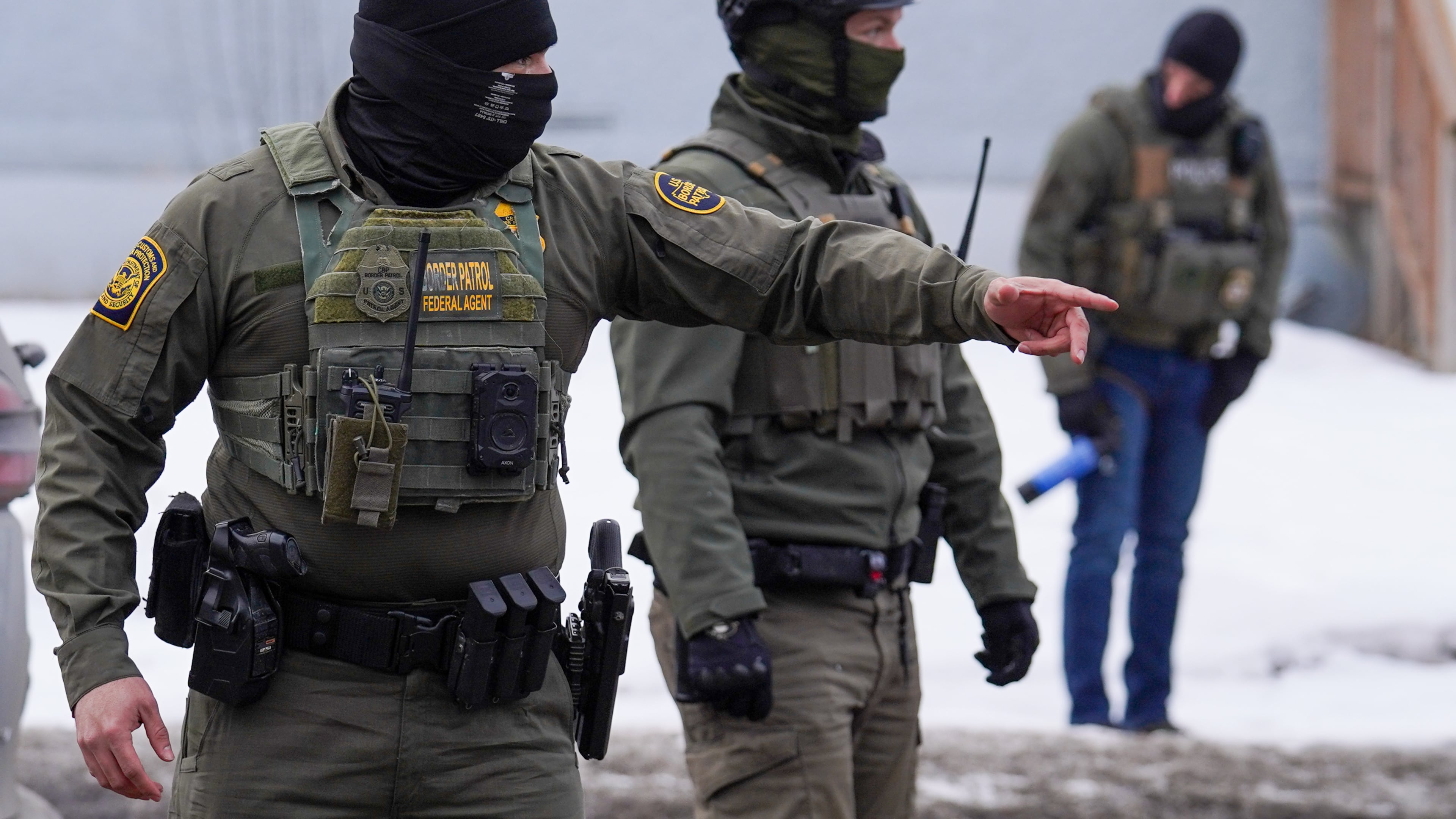 A United States Border Patrol agent gestures to a car while conducting immigration enforcement operations, Thursday, Feb. 5, 2026, in Minneapolis. (AP Photo/Ryan Murphy)