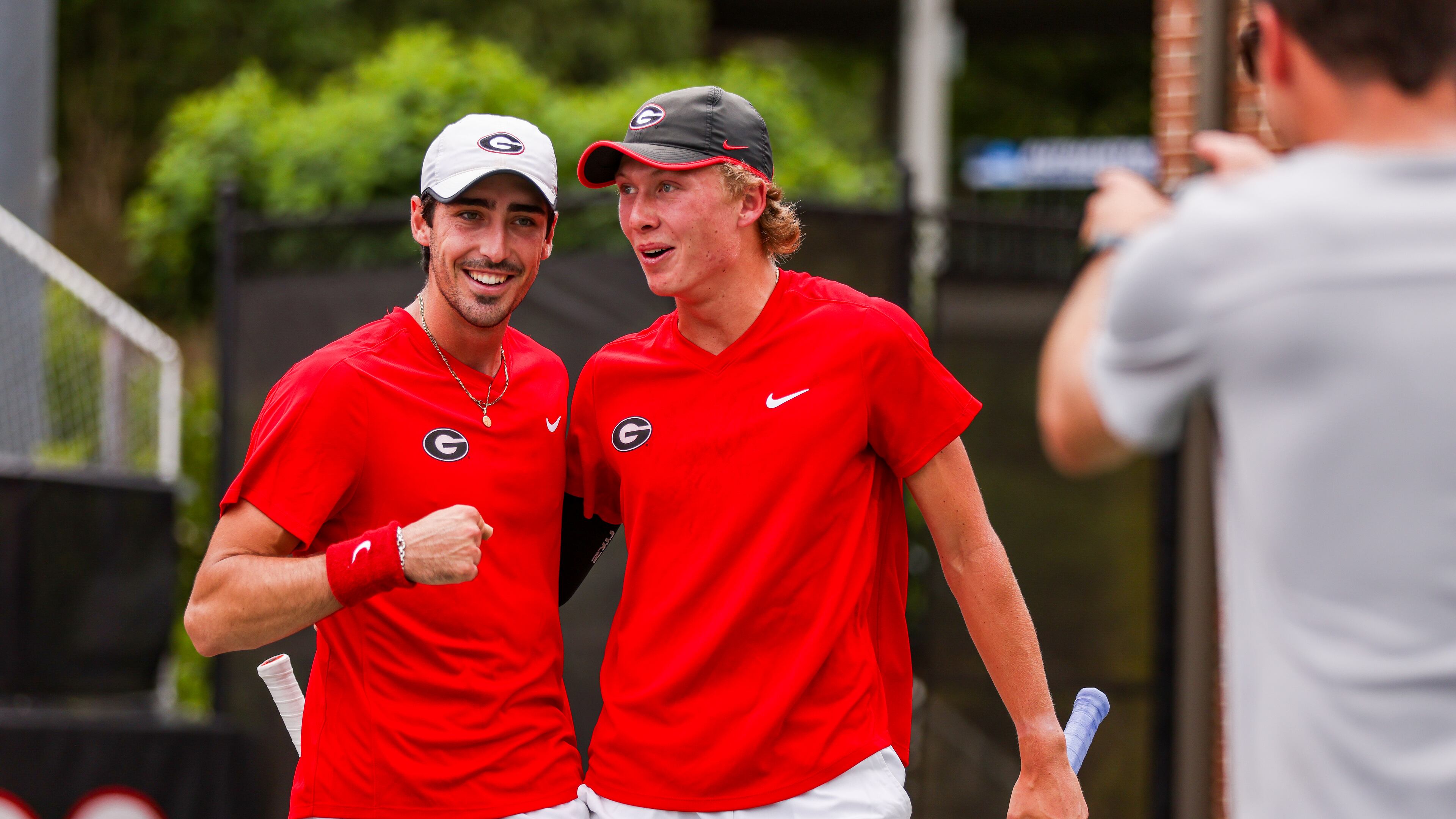 Georgia tennis players Thomas Paulsell (L), and Ethan Quinn celebrate winning n NCAA tournament match against Oklahoma in the second round May 7 at UGA's Dan Magill Tennis Complex. (Tony Walsh/UGA Athletics)