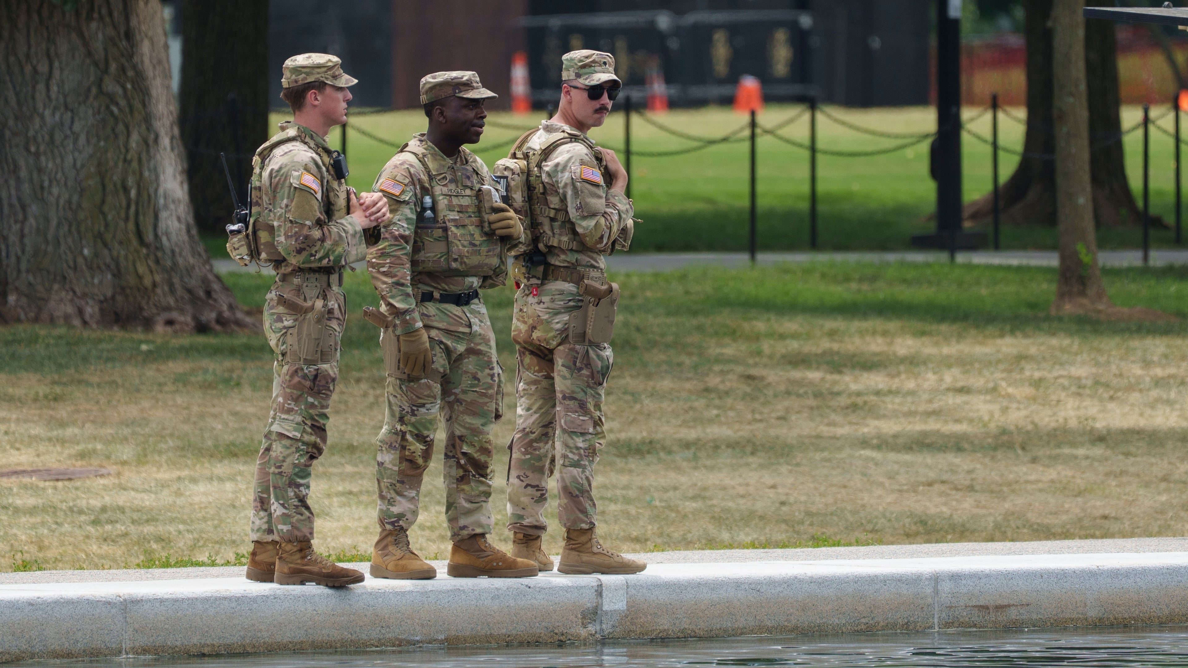 Members of the National Guard stop and look at the Lincoln Memorial Reflecting Pool Sunday, June 21, 2026, on the National Mall in Washington. (AP Photo/Jon Elswick