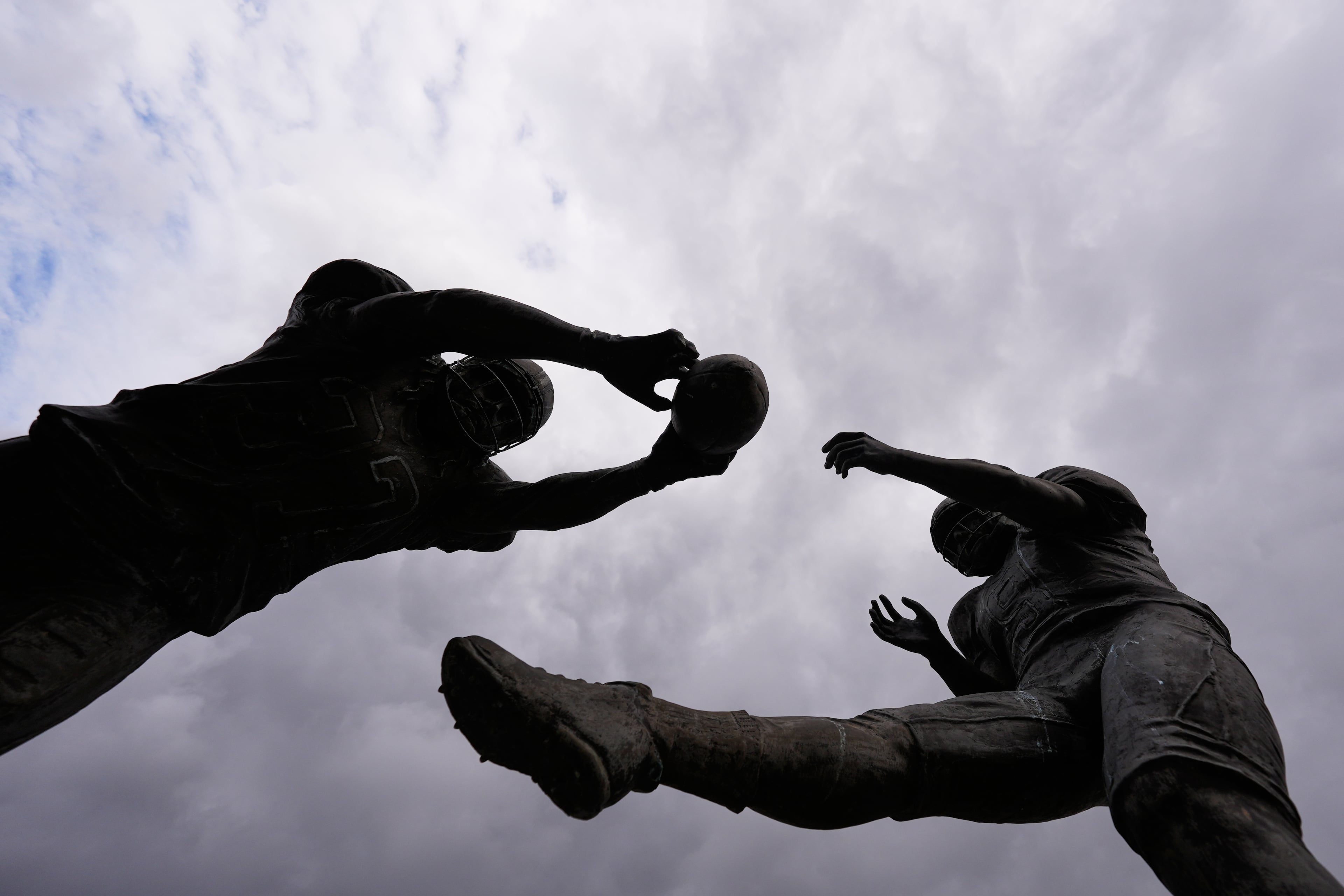 The Rebirth Statue is seen with storm clouds outside the Superdome, before an NFL football game 20 years later between the New Orleans Saints and the Atlanta Falcons, in New Orleans, Monday, Oct. 5, 2026. The statue features New Orleans Saints' Steve Gleason blocking a punt by Atlanta Falcons punter Michael Koenen, in the first Saints home game after Hurricane Katrina. (Gerald Herbert/AP)