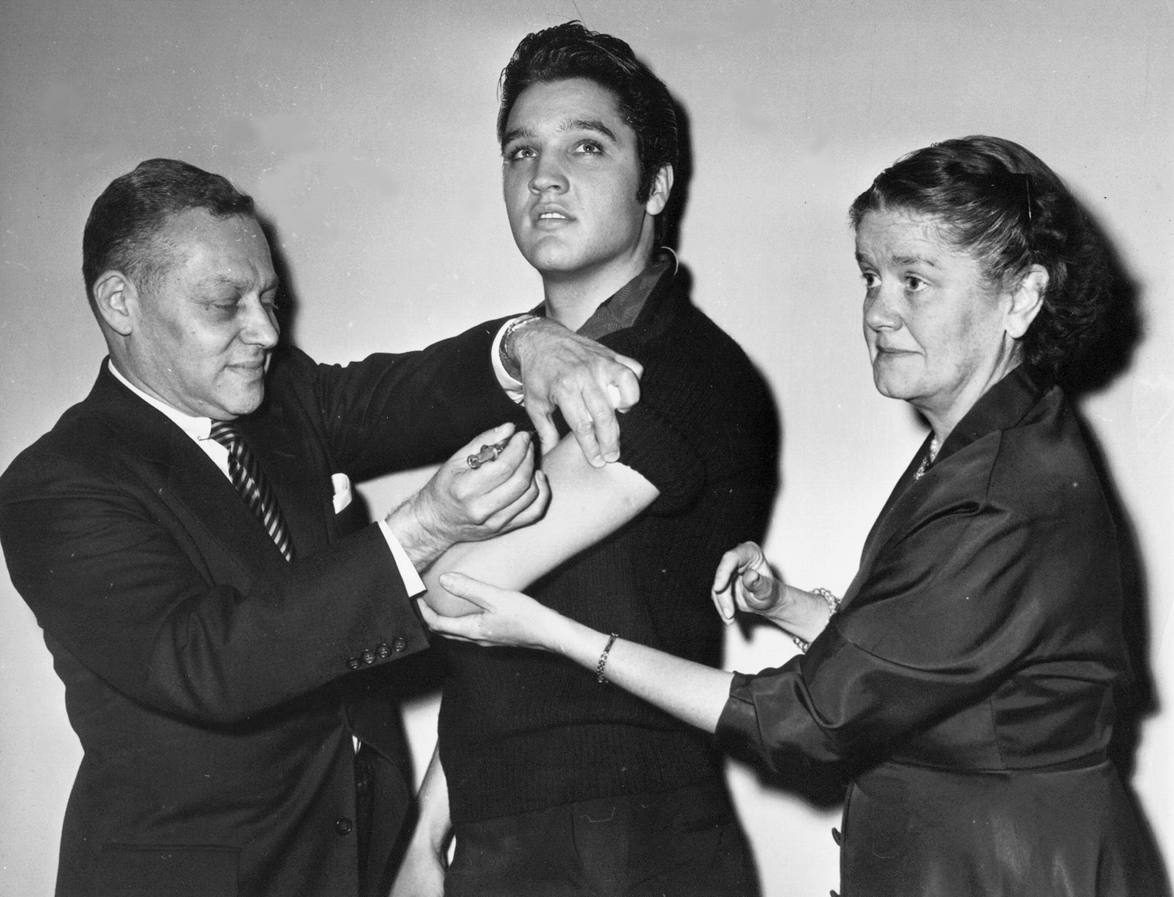 Elvis Presley receives a polio vaccine from Dr. Harold Fuerst (left) as Dr. Leona Baumgartner assists on Oct. 28, 1956, in New York City. America was the birthplace of polio vaccination. Starting from here, the vaccine was sent throughout the rest of the world nearly bringing polio to an end. (AP 1956)