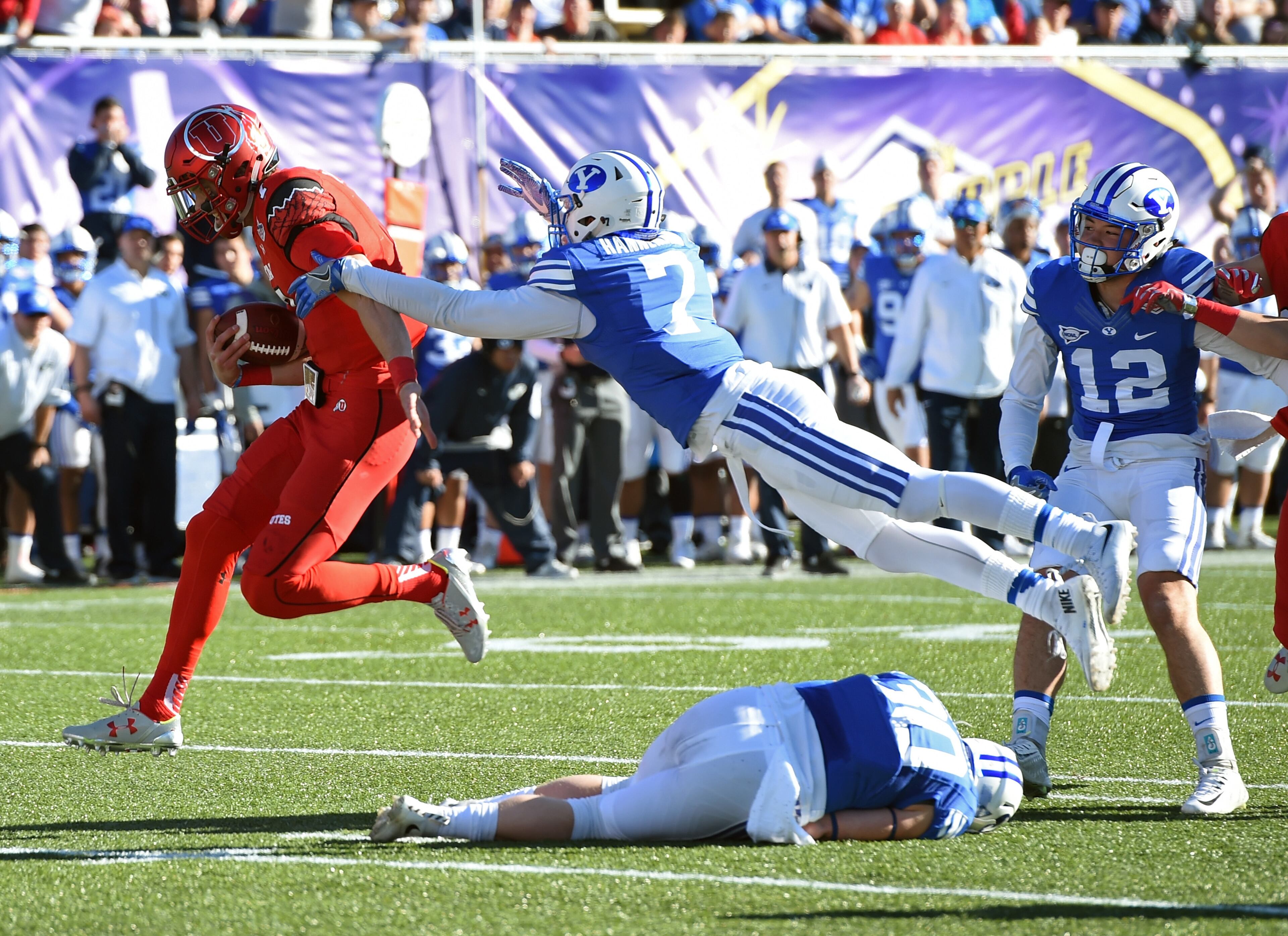 LAS VEGAS, NV - DECEMBER 19: Quarterback Travis Wilson #7 of the Utah Utes runs for a touchdown against defensive back Micah Hannemann #7 of the Brigham Young Cougars during the Royal Purple Las Vegas Bowl at Sam Boyd Stadium on December 19, 2015 in Las Vegas, Nevada. Utah won 35-28. (Photo by Ethan Miller/Getty Images)