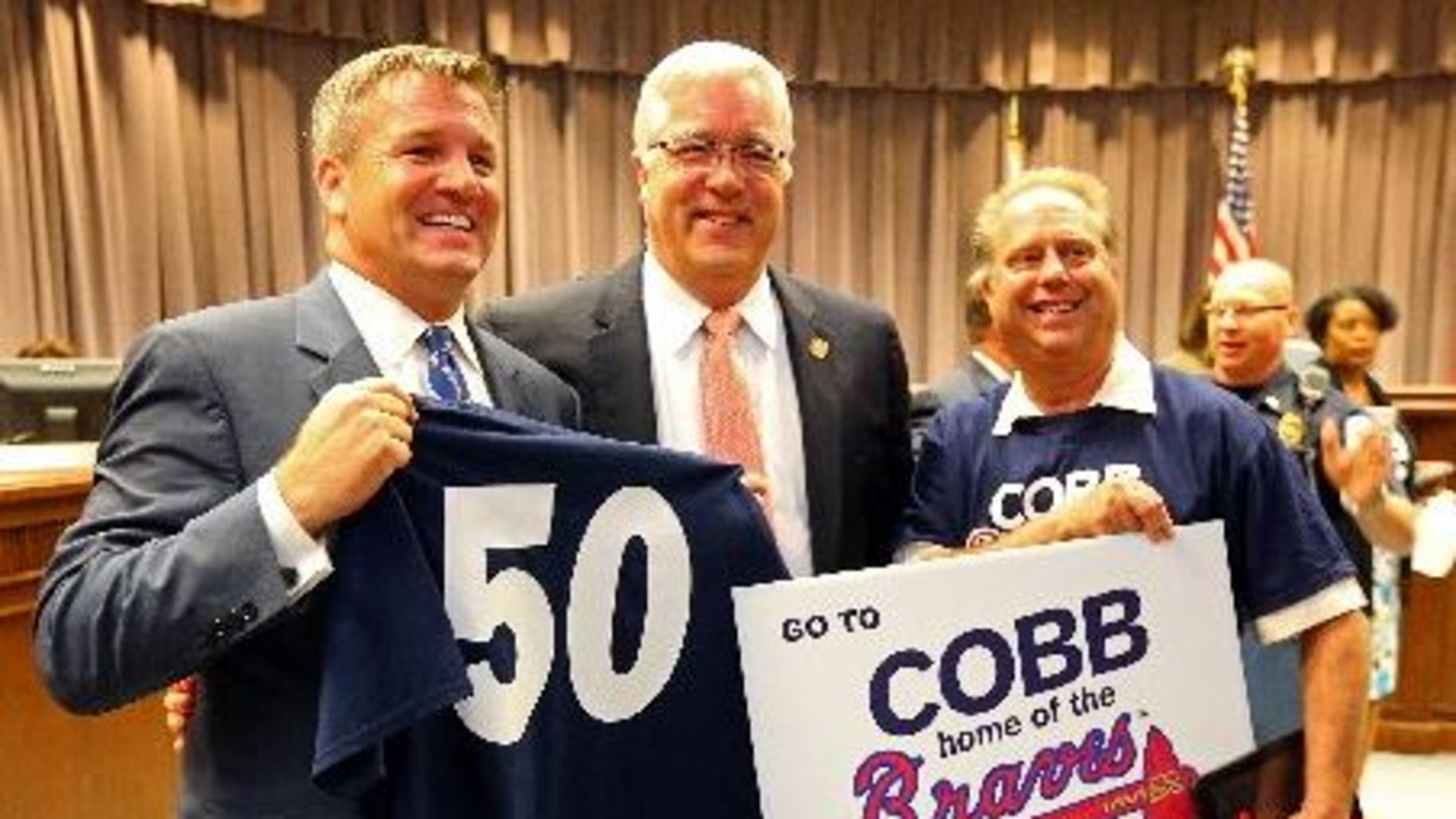 Cobb County Chairman Tim Lee poses with Braves supporters in May 2014. (AJC file photo / Curtis Compton)