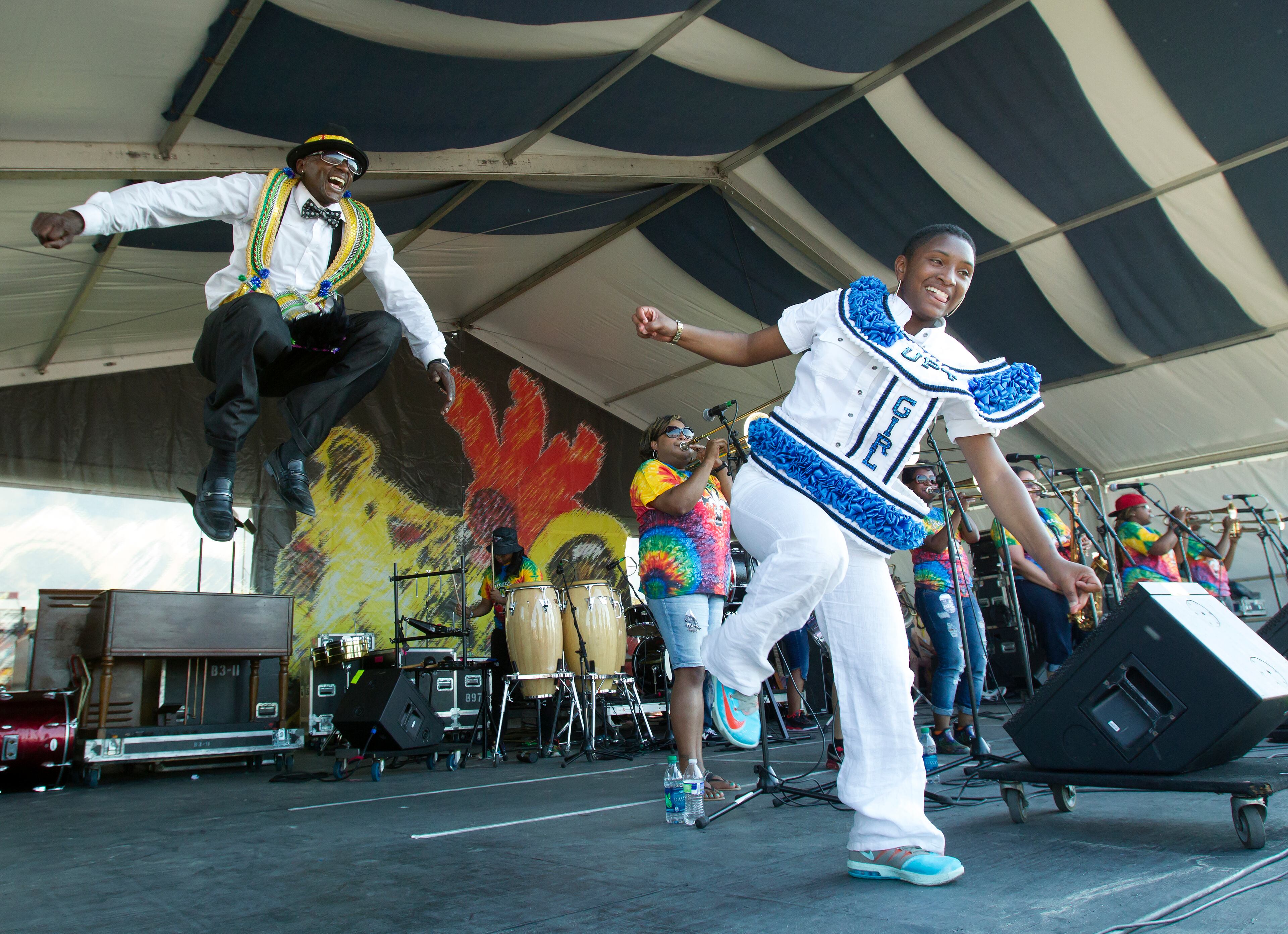 Grand marshals Oliver 'Squirt Man' Hunter Jr., of The Nation, left, and Terrylyn Dorsey of the Single Men Social Aid and Pleasure Club join the Original Pinettes Brass Band on the Jazz and Heritage Stage during the New Orleans Jazz and Heritage Festival Saturday, May 2, 2015, at the New Orleans Fair Grounds Race Course.(Scott Threlkeld/The Advocate via AP) MAGS OUT; INTERNET OUT; NO SALES; TV OUT; NO FORNS; LOUISIANA BUSINESS INC. OUT (INCLUDING GREATER BATON ROUGE BUSINESS REPORT, 225, 10/12, INREGISTER, LBI CUSTOM); MANDATORY CREDIT