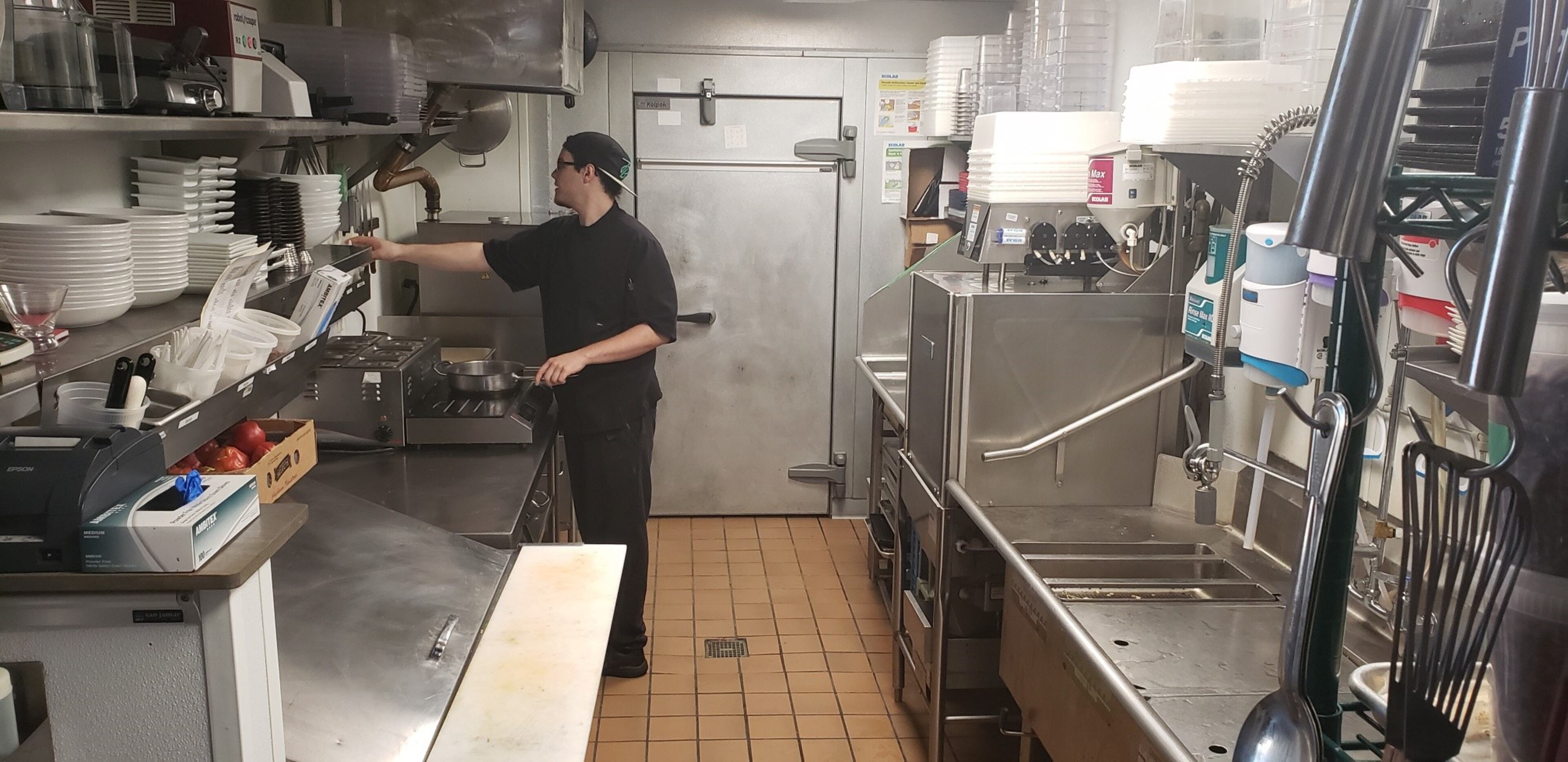Rootstock and Vine line cook Matt Duhe works in the small kitchen at the Woodstock restaurant. "I say that my kitchen is so small it s very possible one of my guys is going to get pregnant," jokes executive chef Todd Webster.