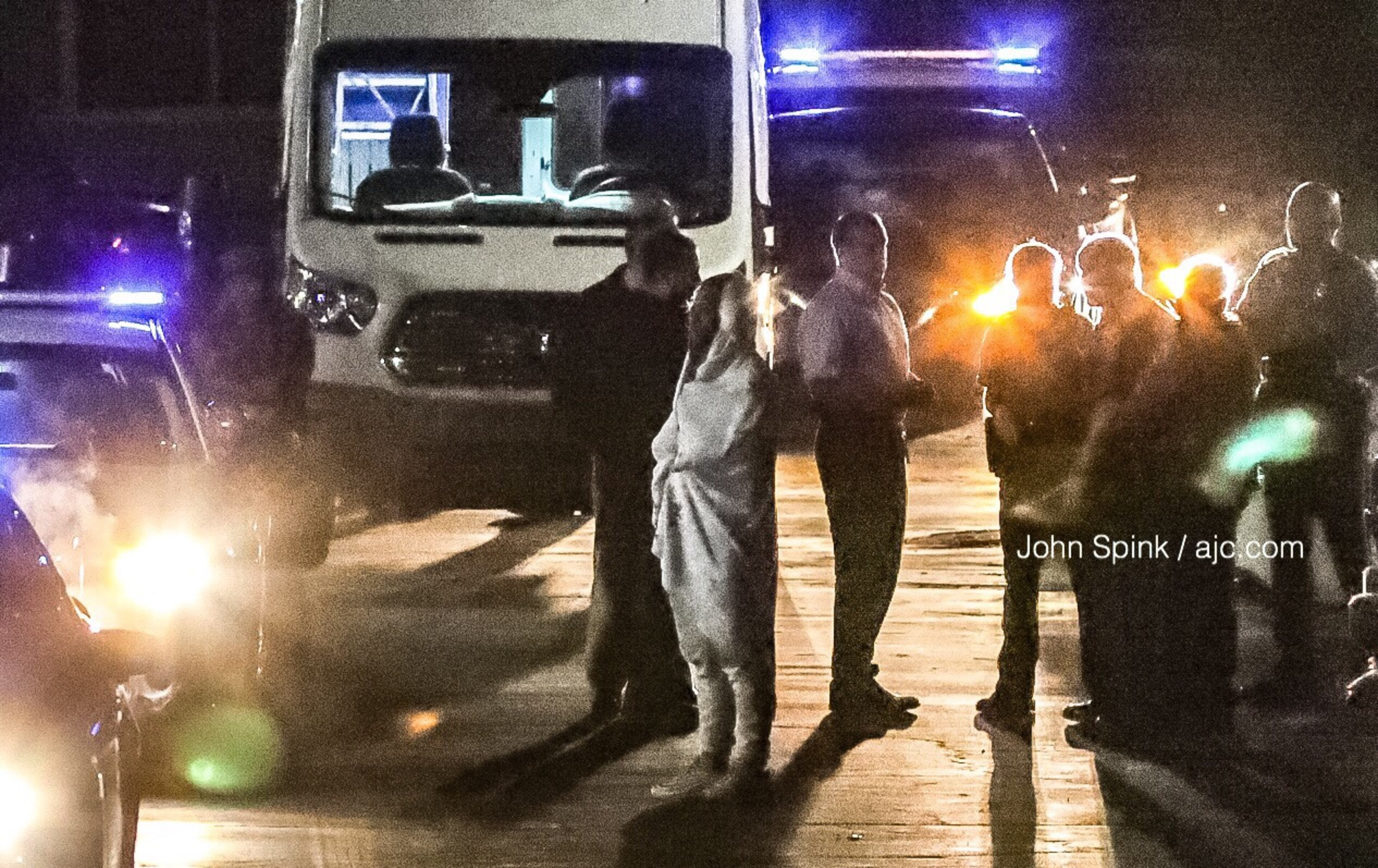 Officers gather at the scene of a double homicide at an apartment complex on Peachtree Corners Circle on Thursday morning.