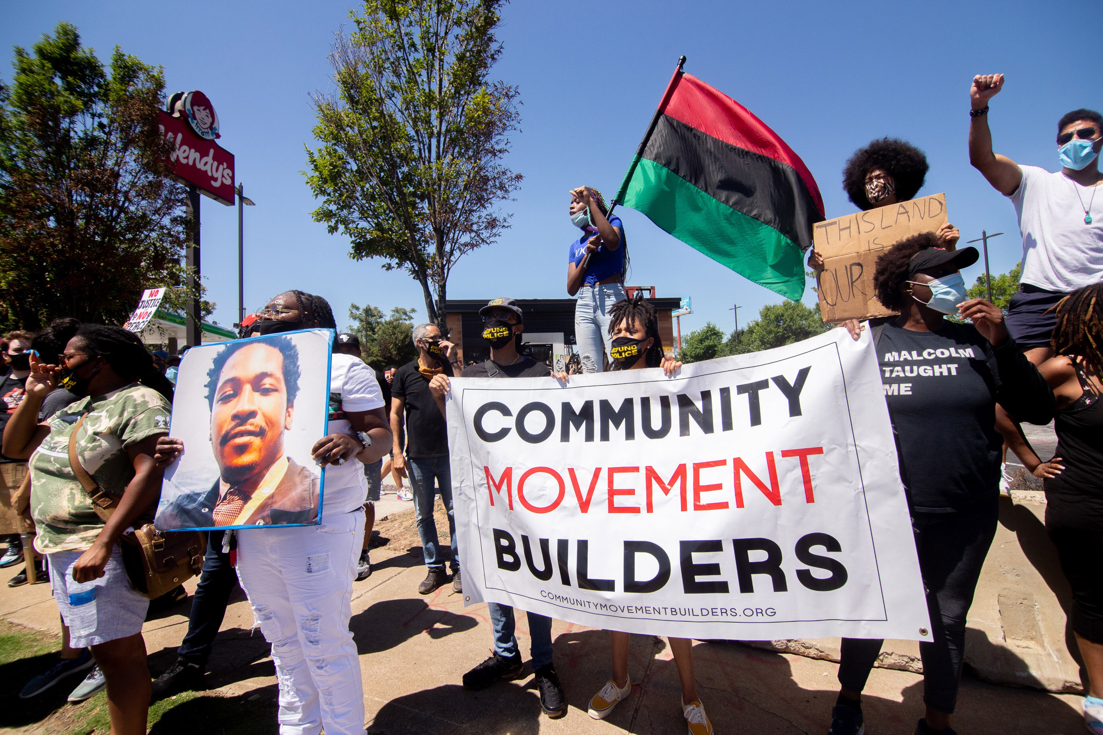 Protesters holds up a sign during the 'Take Back the Wendy's' March & Rally on University Avenue in Atlanta on Saturday, July 11, 2020. The march started at the Community Movement Builders community house and ended at the Wendy's. STEVE SCHAEFER FOR THE ATLANTA JOURNAL-CONSTITUTION
