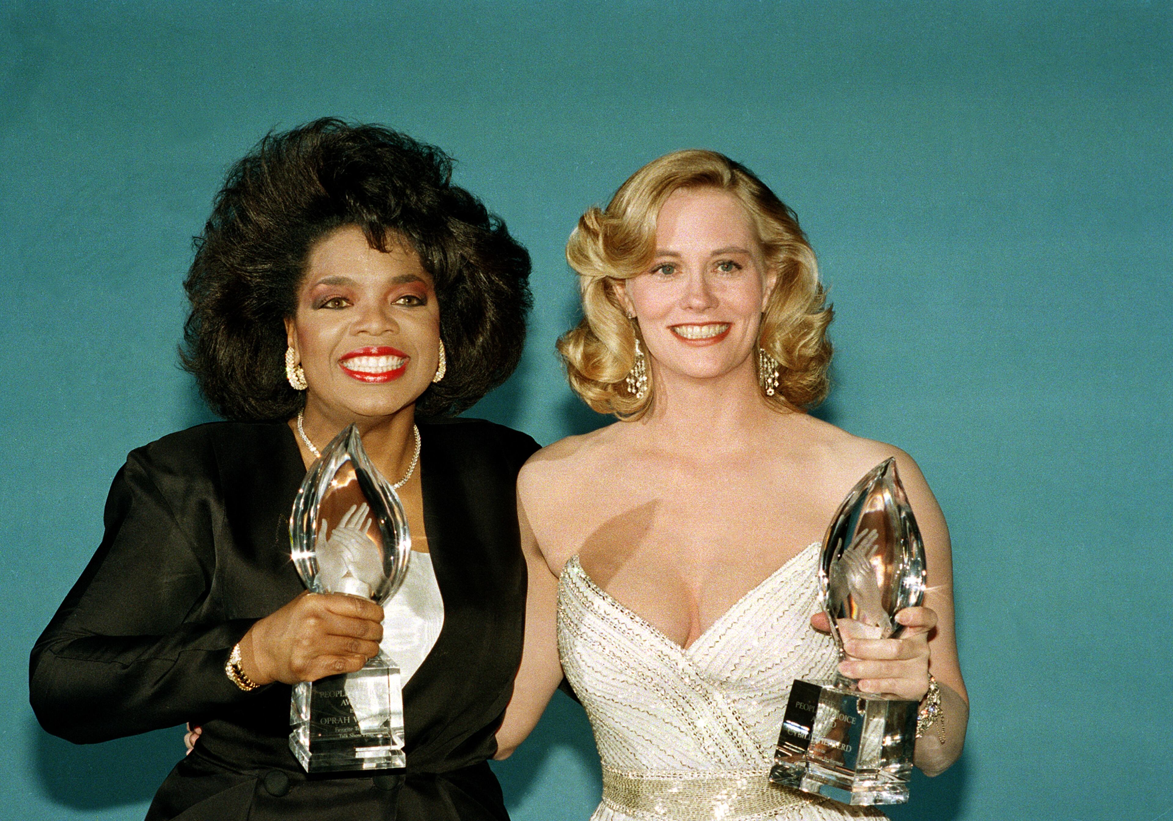 American actress Cybill Shepherd and talk show host Oprah Winfrey pose with their respective awards at the 20th Century Fox Studios during the People's Choice Awards in Los Angeles, Calif., March 15, 1987. (AP Photo/Bob Galbraith)