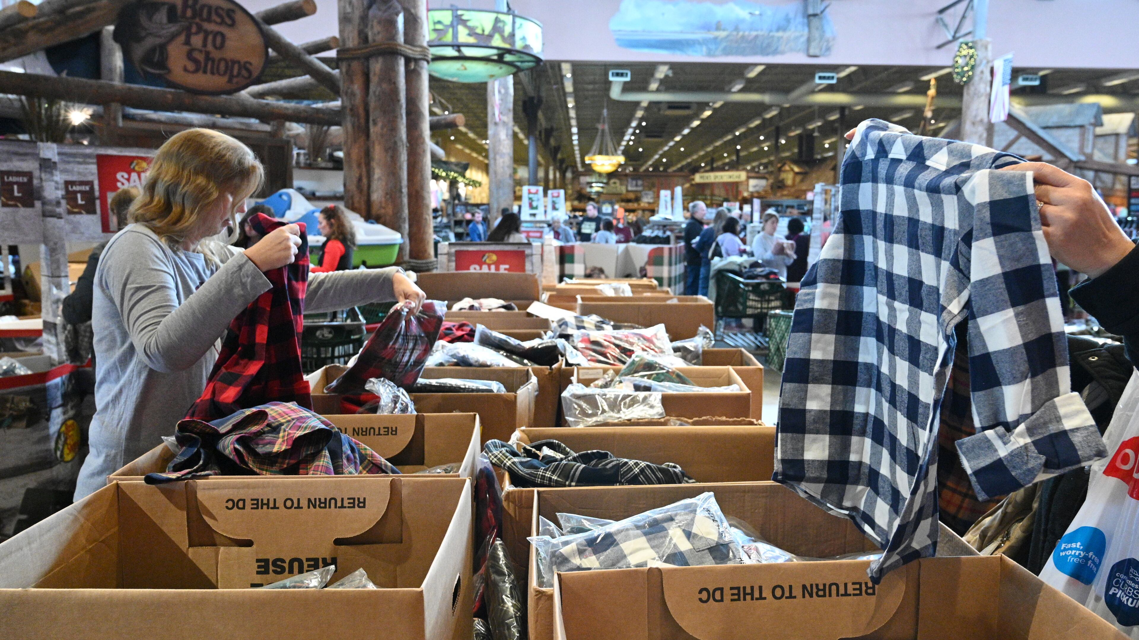 Black Friday shoppers search for special discounts at the Bass Pro Shops at Sugarloaf Mills in Lawrenceville on Friday, Nov. 25, 2022. (Hyosub Shin/AJC)