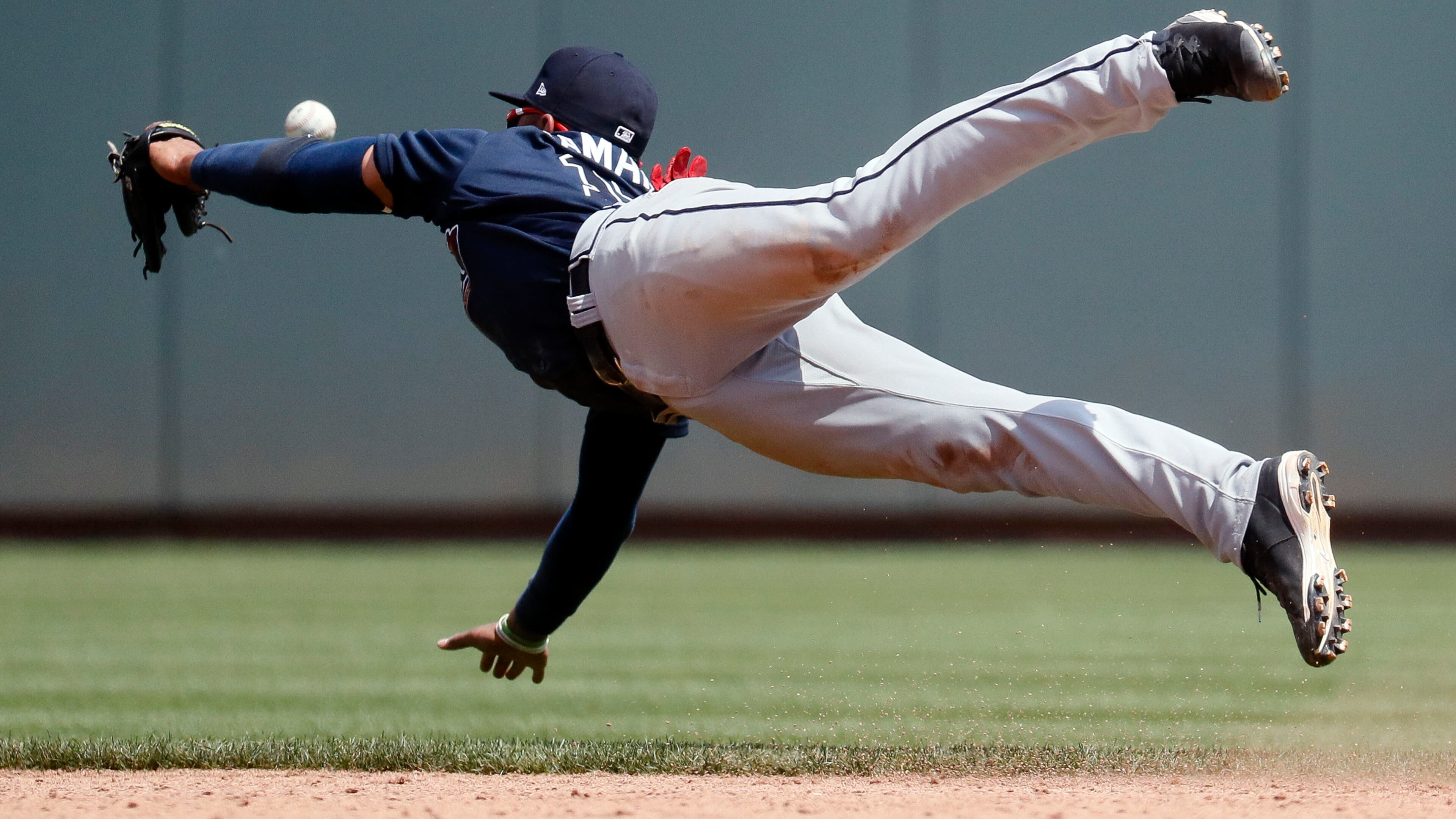 Atlanta Braves' Johan Camargo misses a single by Cincinnati Reds' Eugenio Suarez in the fifth inning of a baseball game, Sunday, June 4, 2017, in Cincinnati. (AP Photo/John Minchillo)
