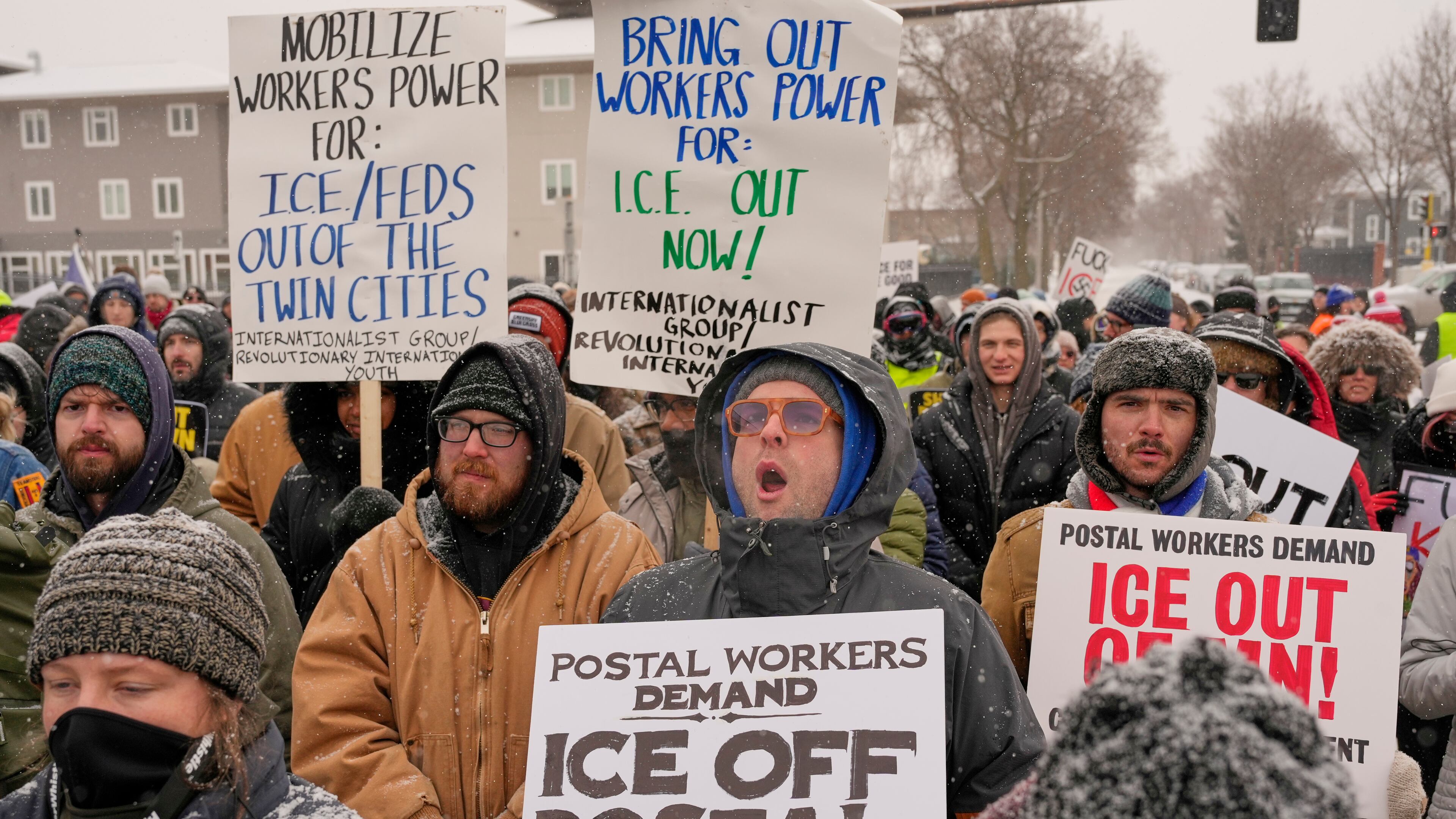 People march and gather near the post office during a protest, Sunday, Jan. 18, 2026, in Minneapolis. (AP Photo/Yuki Iwamura)