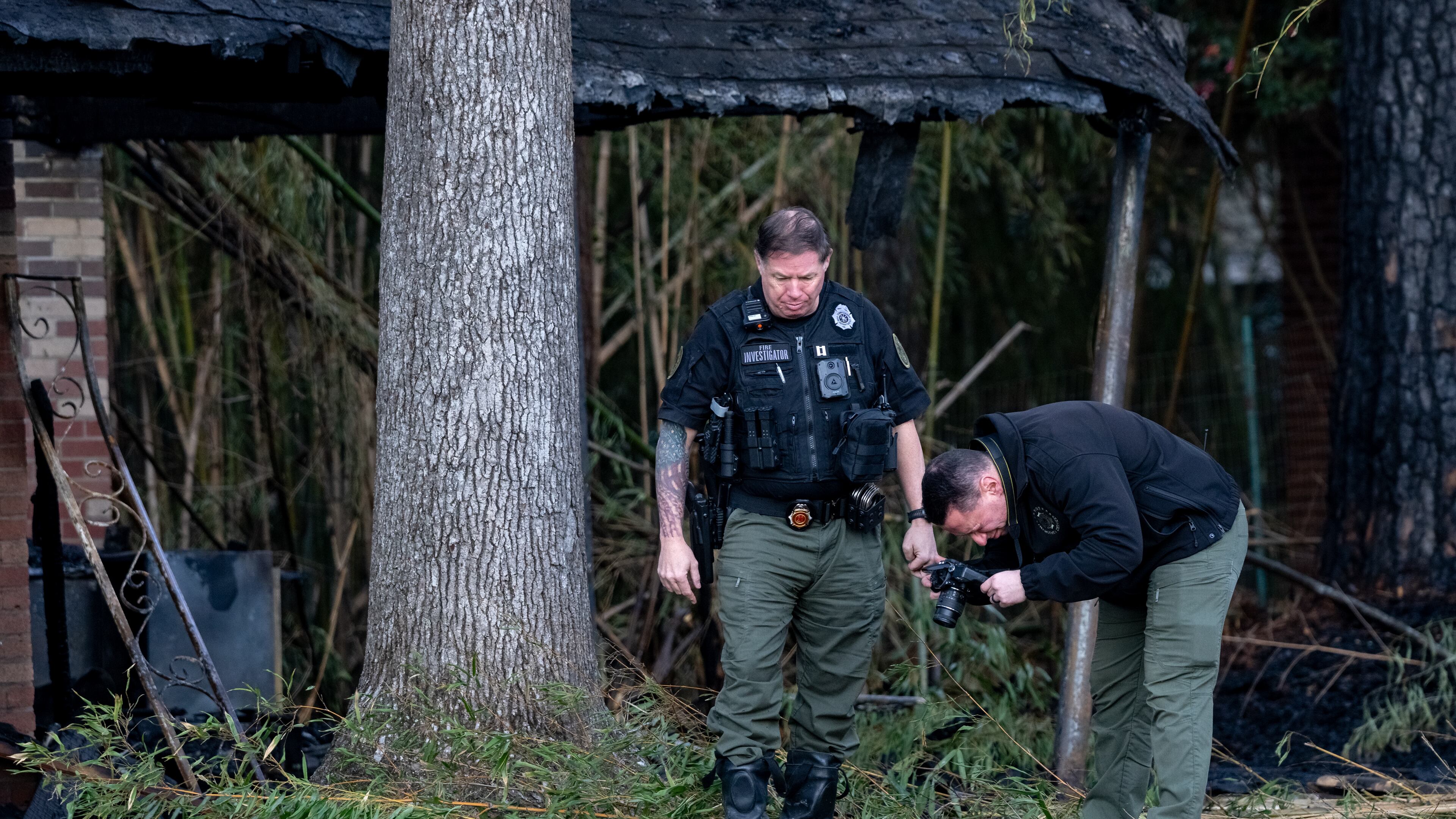 Cobb County fire investigators survey the scene on Oakland Drive that claimed the life of one person Friday.