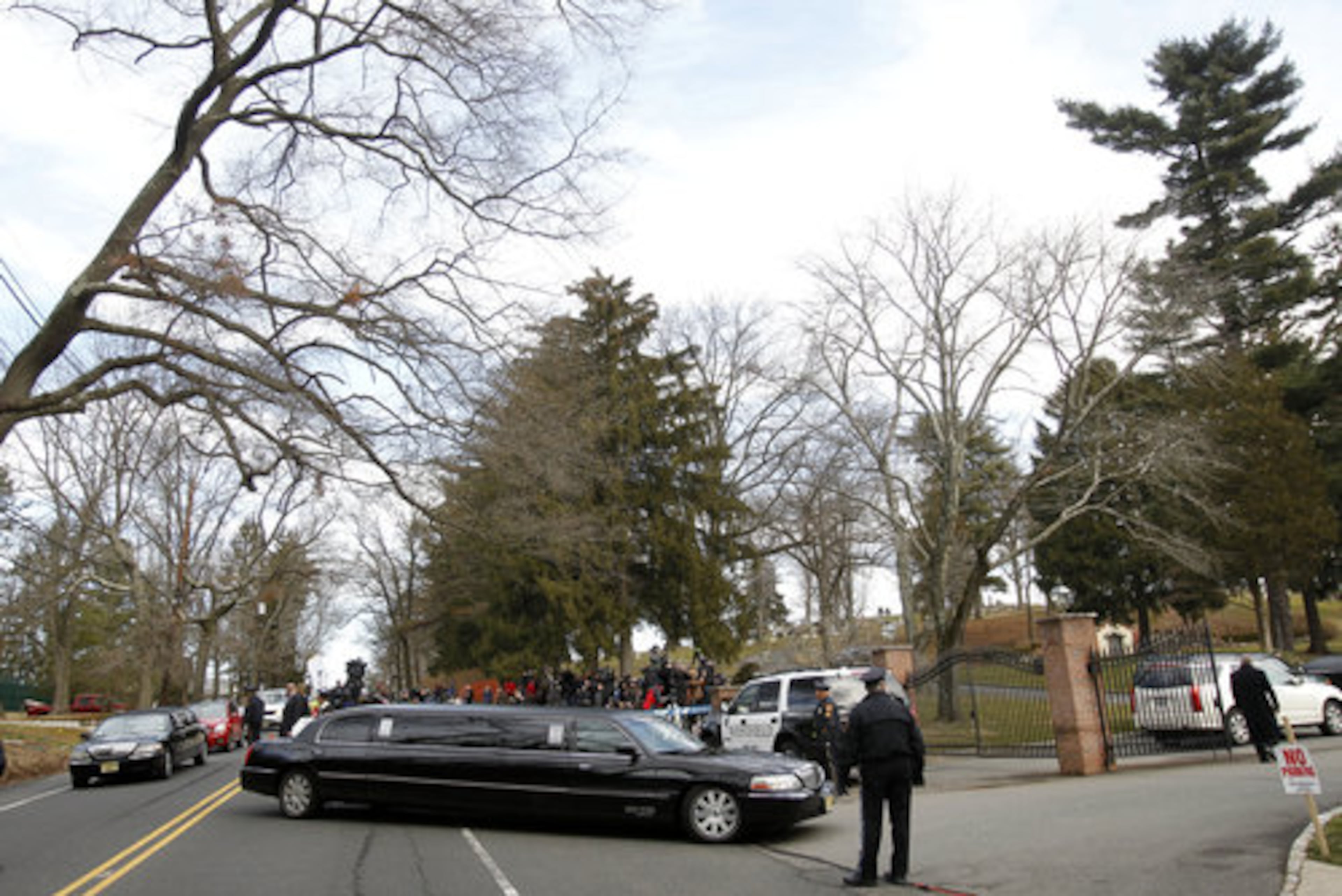 Limos follow the gold hearse carrying the body of Whitney Houston into Fairview Cemetery for her burial in Westfield, N.J., Sunday, Feb. 19, 2012.
