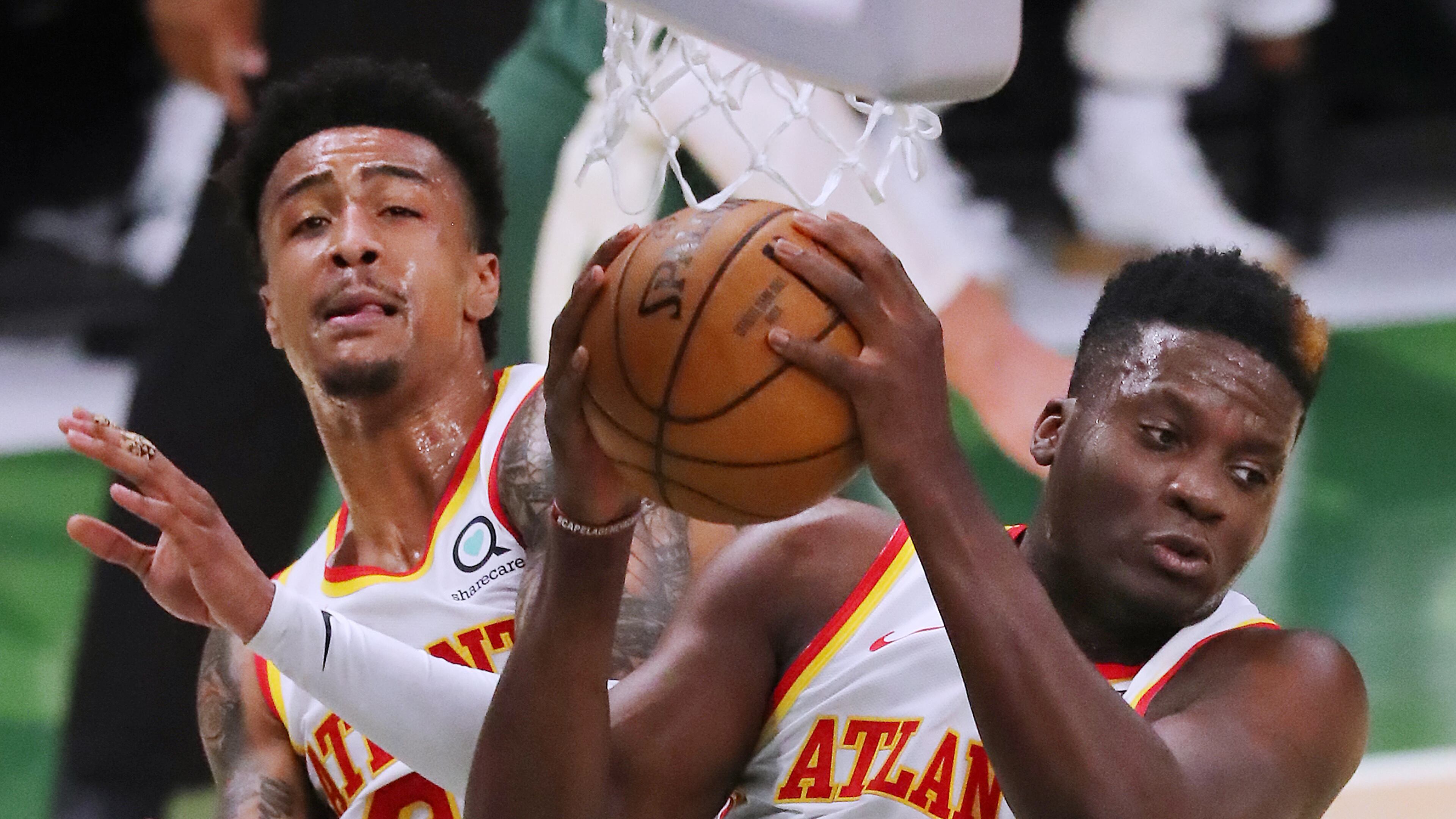 062321 Milwaukee: Atlanta Hawks defenders John Collins and Clint Capela goe up for the rebound against the Milwaukee Bucks in game 1 of the NBA Eastern Conference Finals at Fiserv Forum on Wednesday, June 23, 2021, in Milwaukee. “Curtis Compton / Curtis.Compton@ajc.com”